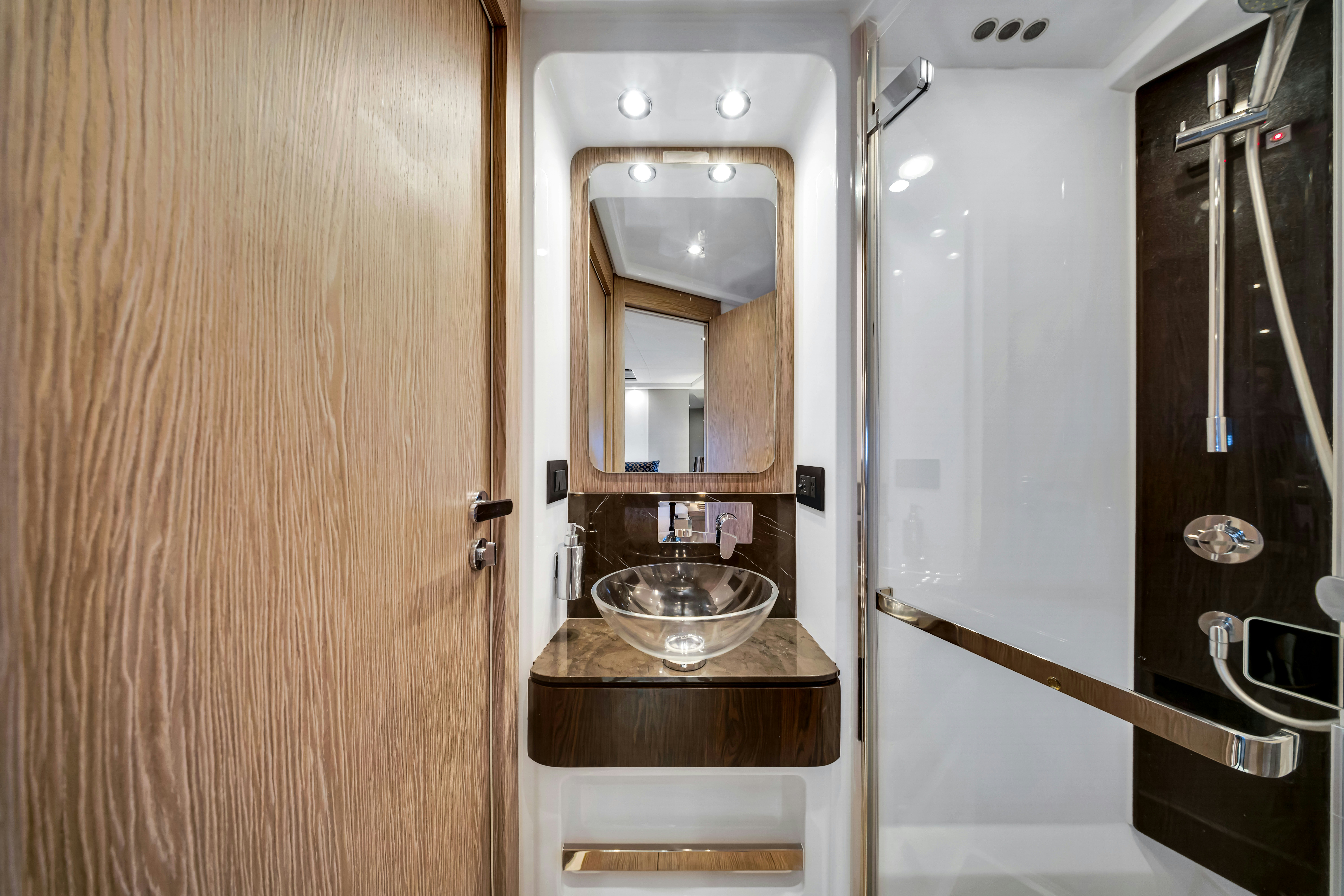 a bathroom with a sink and a mirror aboard AMF Yacht for Sale