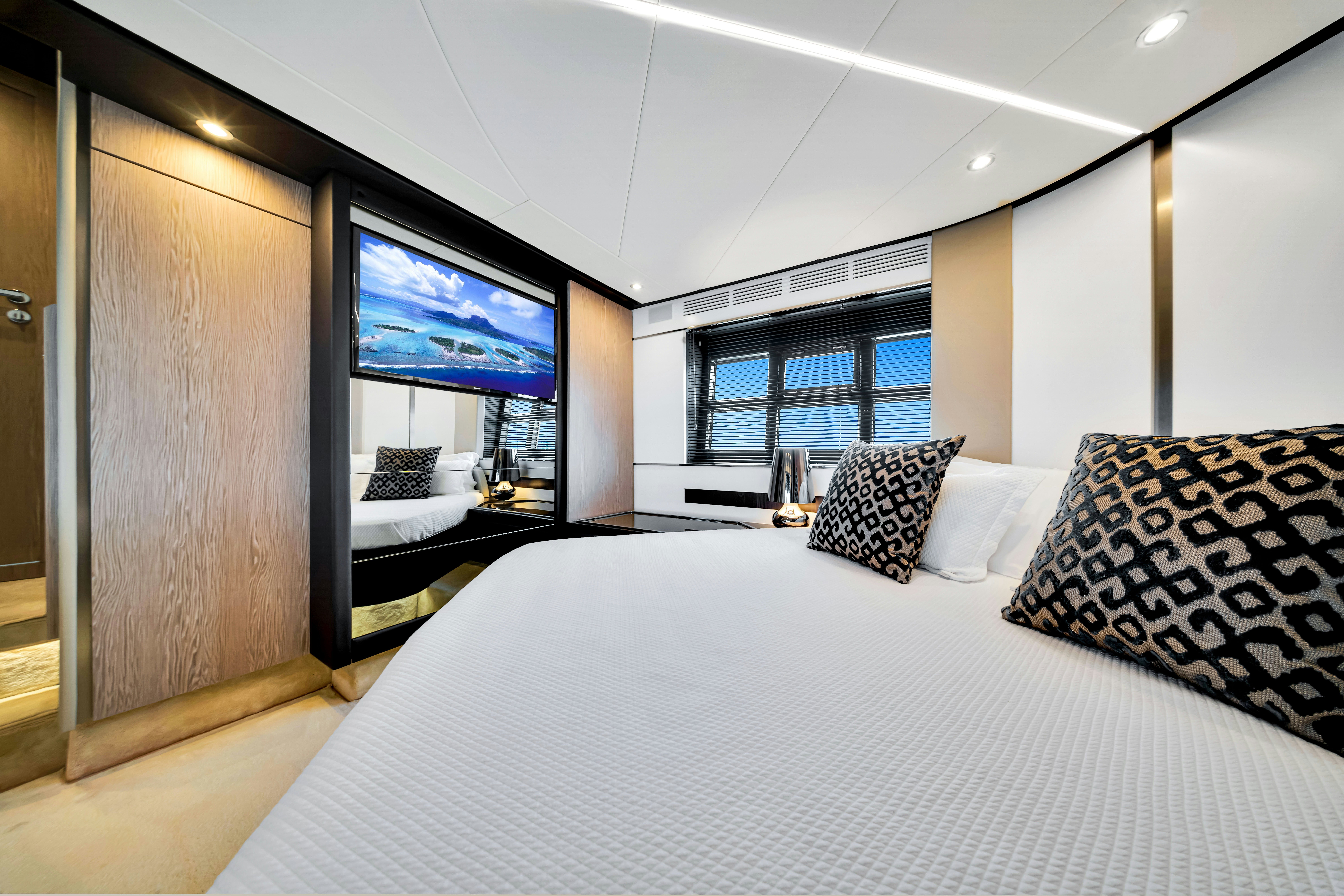 a room with a bed and a tv on the wall aboard AMF Yacht for Sale