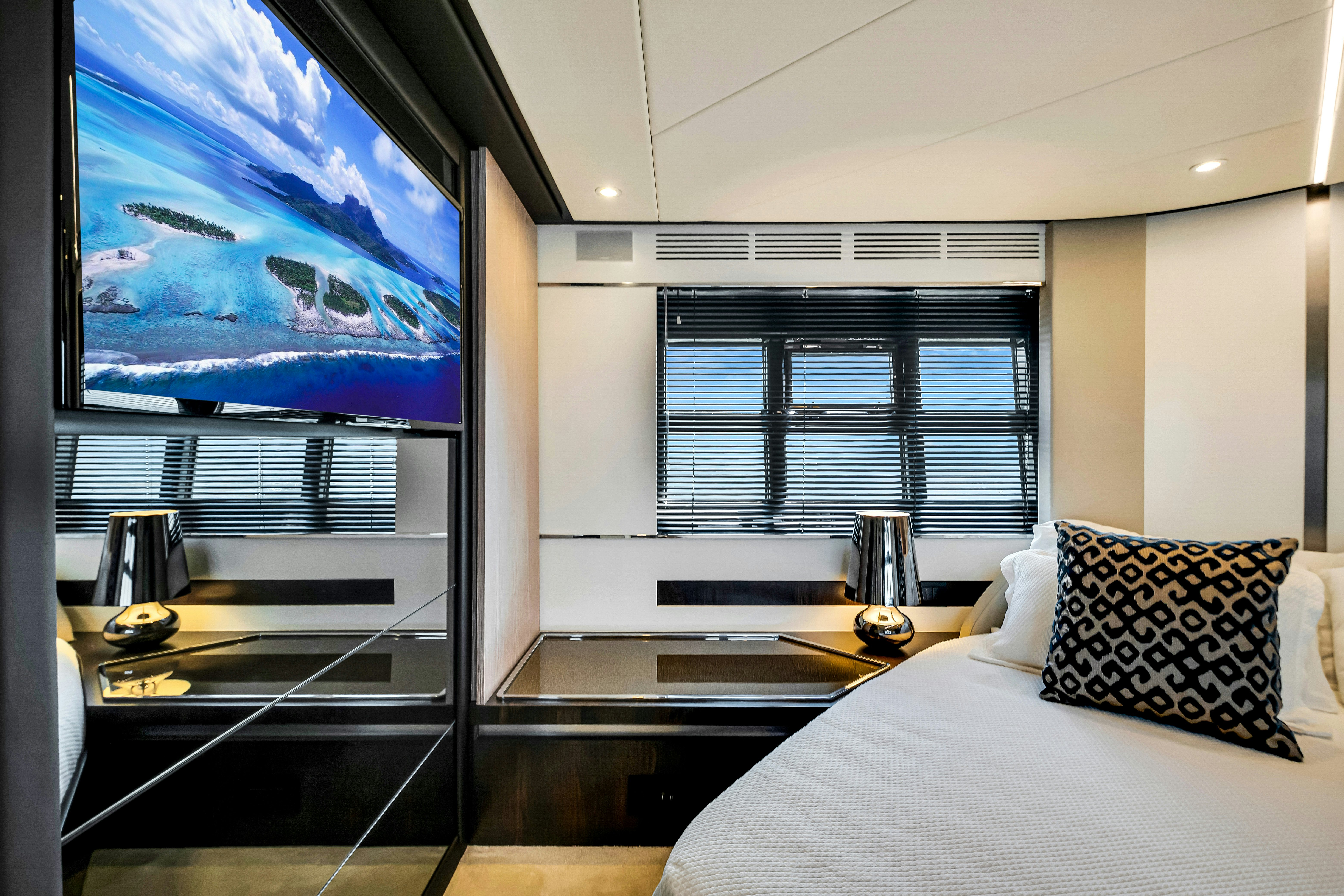 a bedroom with a large screen aboard AMF Yacht for Sale