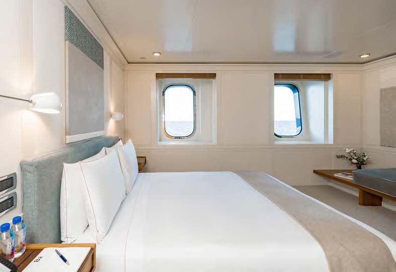 a bed with a white sheet aboard HBC Yacht for Sale