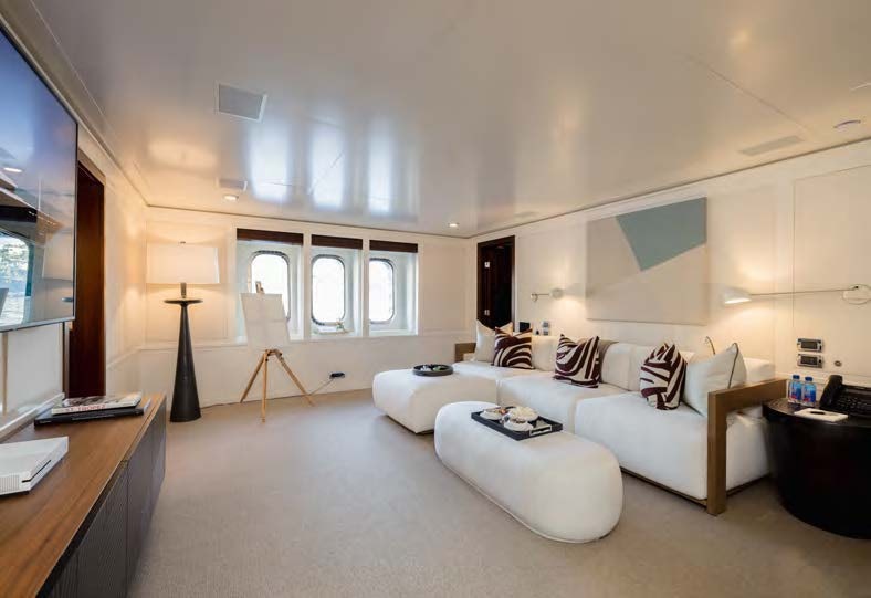 a living room with a white couch aboard HBC Yacht for Sale