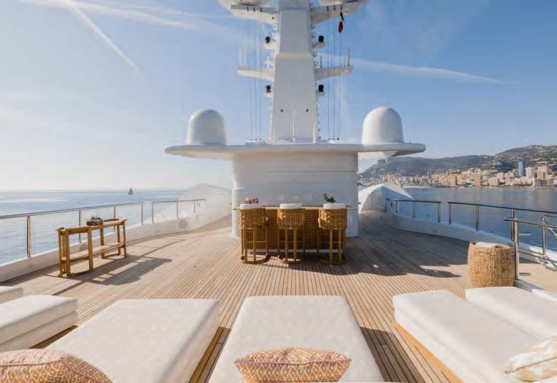 a room with a table and chairs on it aboard HBC Yacht for Sale