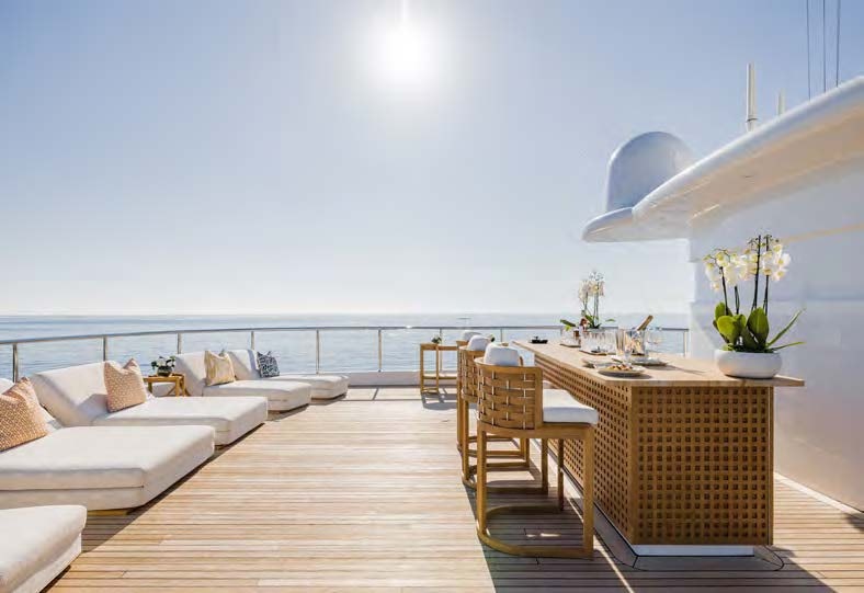 a room with a table and chairs aboard HBC Yacht for Sale