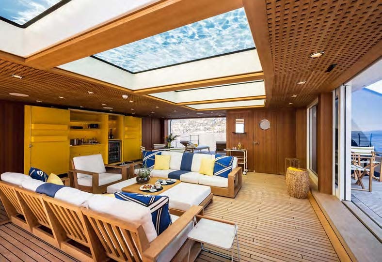 a living room with a wood floor aboard HBC Yacht for Sale
