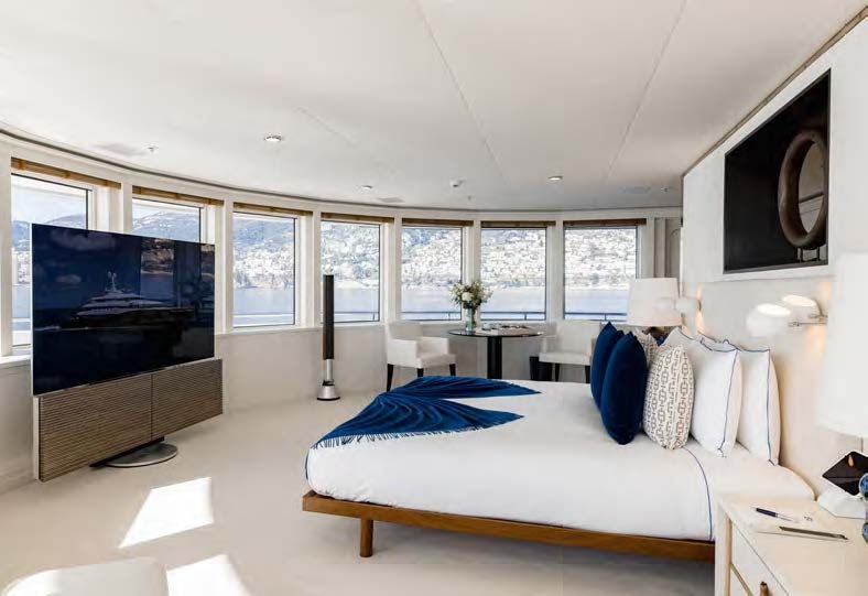 a bedroom with a large tv aboard HBC Yacht for Sale