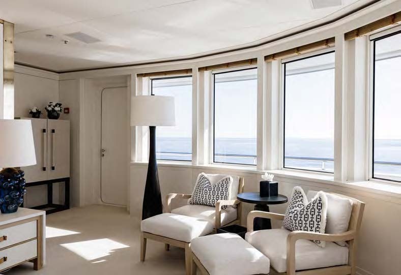 a living room with white furniture aboard HBC Yacht for Sale