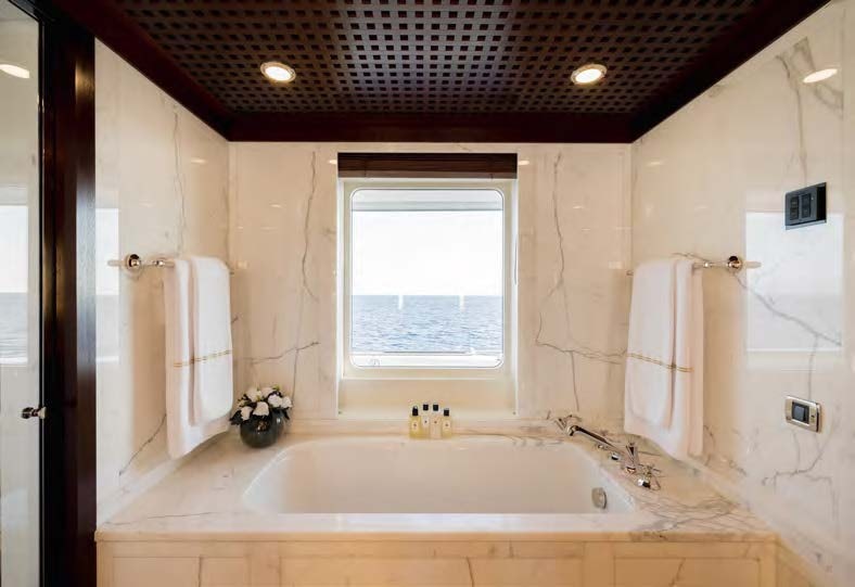 a bathroom with a bathtub and a sink aboard HBC Yacht for Sale