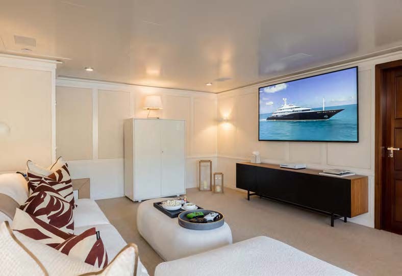a living room with a tv and furniture aboard HBC Yacht for Sale