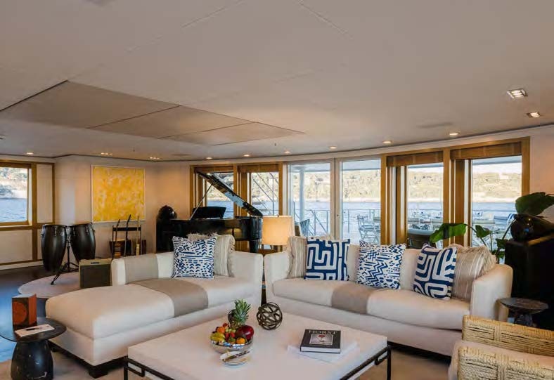 a living room with couches and a table aboard HBC Yacht for Sale