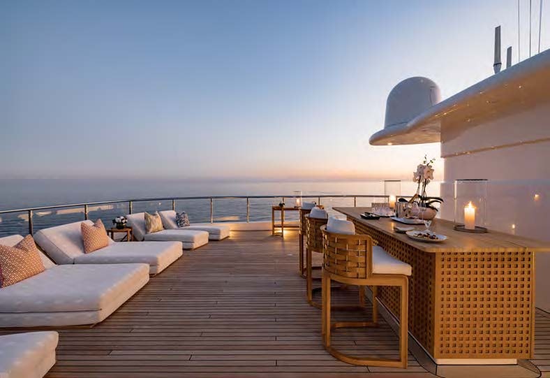 a large room with a couch and a table and chairs aboard HBC Yacht for Sale