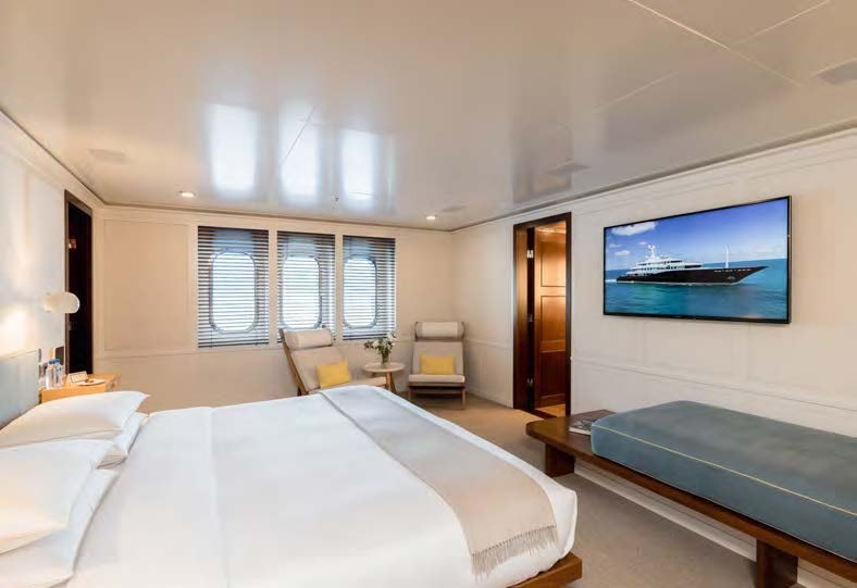 a hotel room with a bed and a tv aboard HBC Yacht for Sale