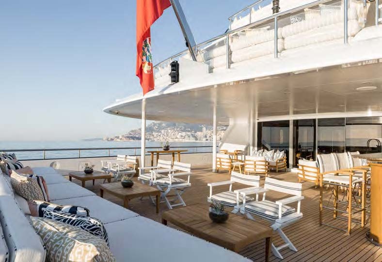 a room with tables and chairs aboard HBC Yacht for Sale