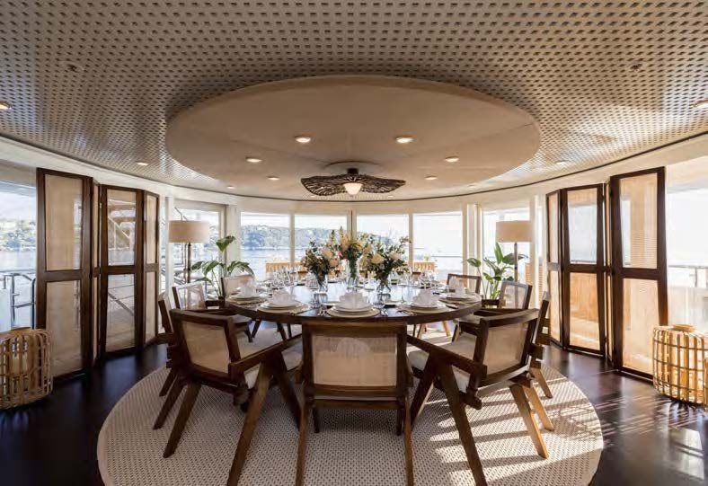 a dining room with a table and chairs aboard HBC Yacht for Sale