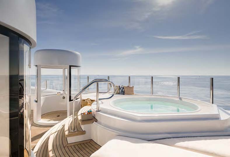 a large pool next to a large white building aboard HBC Yacht for Sale