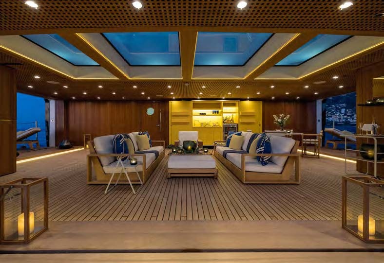 a large room with a couch and a table aboard HBC Yacht for Sale