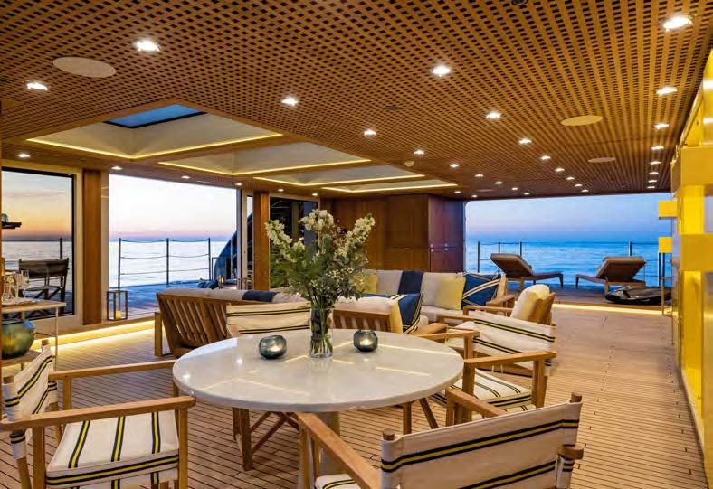 a room with a table and chairs aboard HBC Yacht for Sale