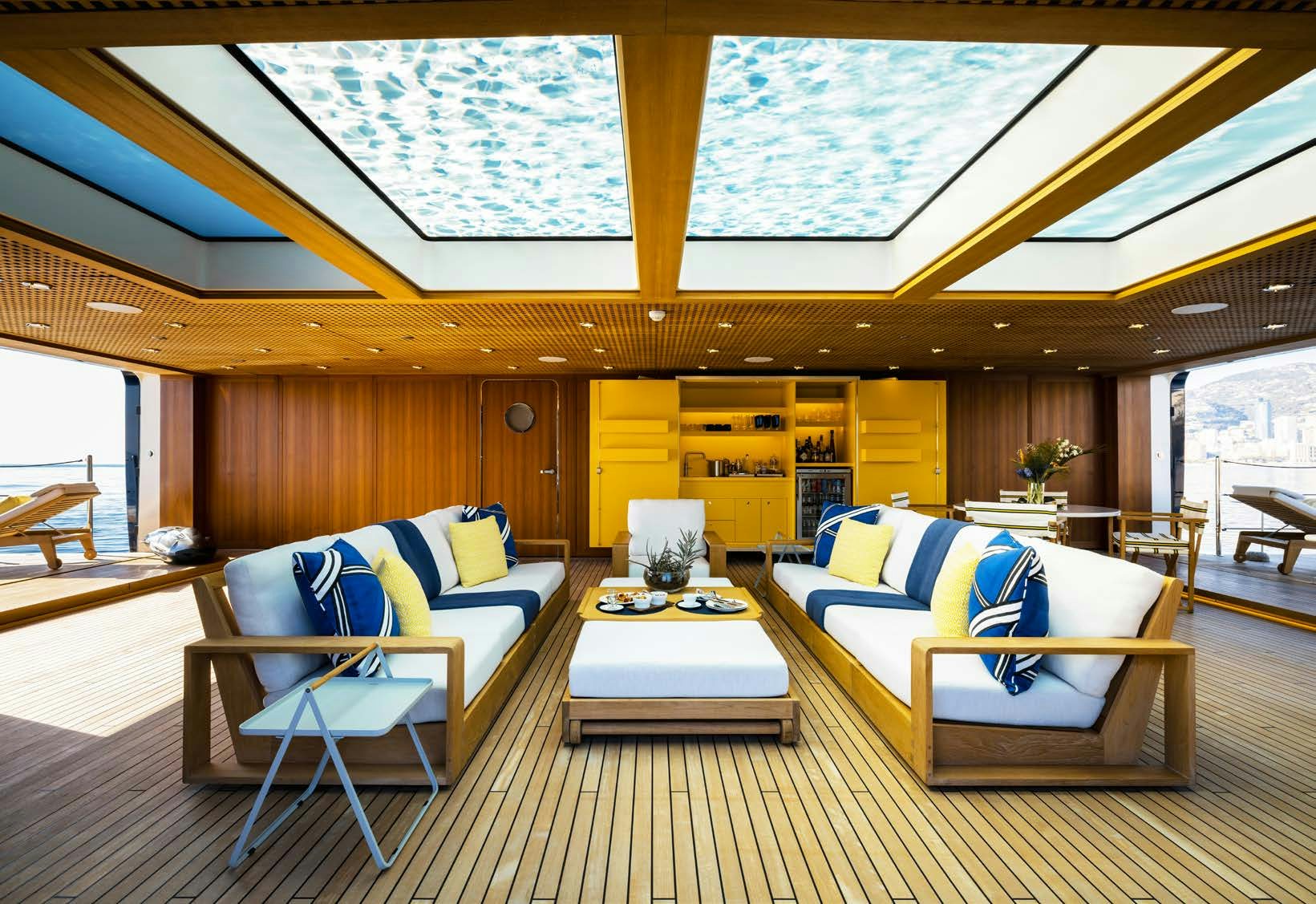 a room with a couch and a table aboard HBC Yacht for Sale