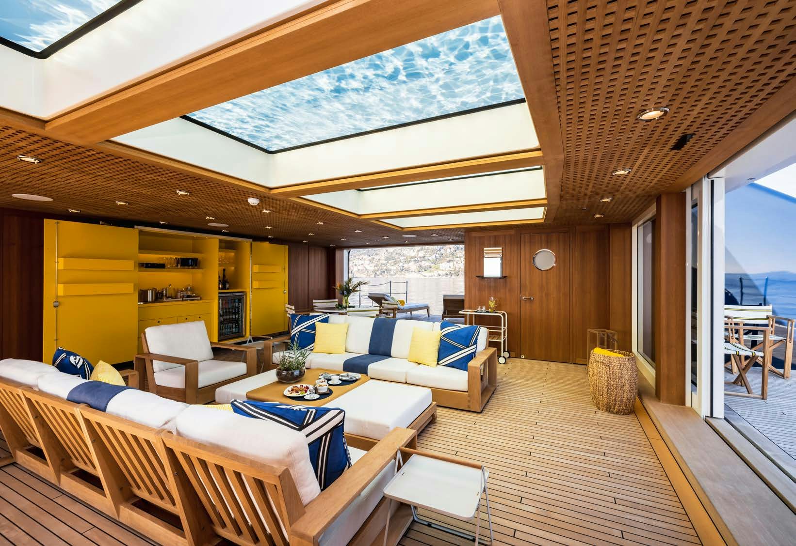 a living room with a wood floor aboard HBC Yacht for Sale