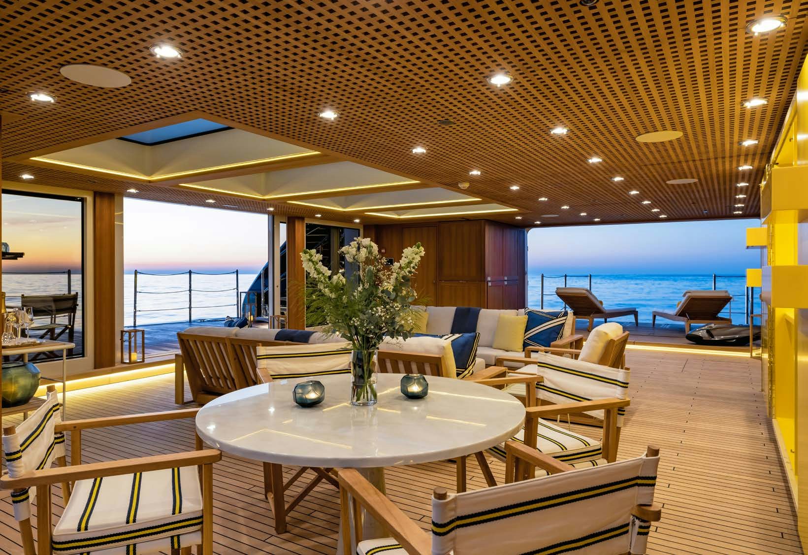 a room with a table and chairs aboard HBC Yacht for Sale