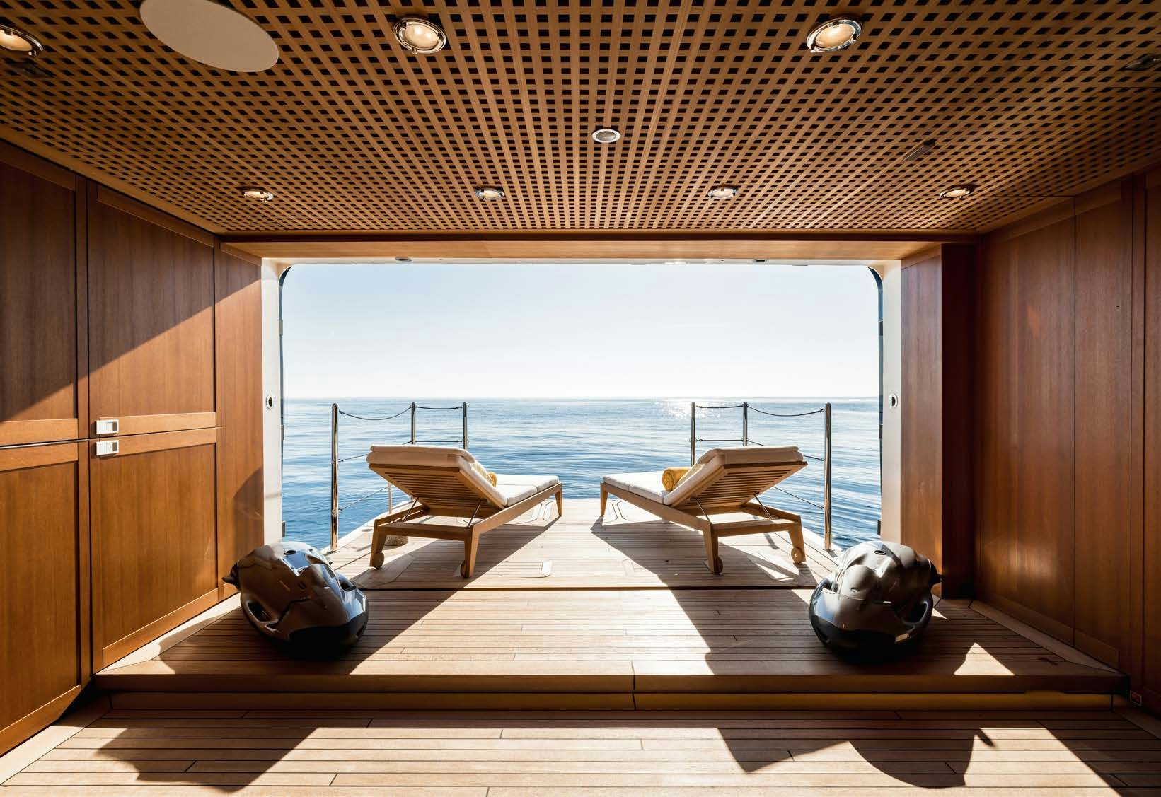 a room with a view of the ocean and a bench aboard HBC Yacht for Sale