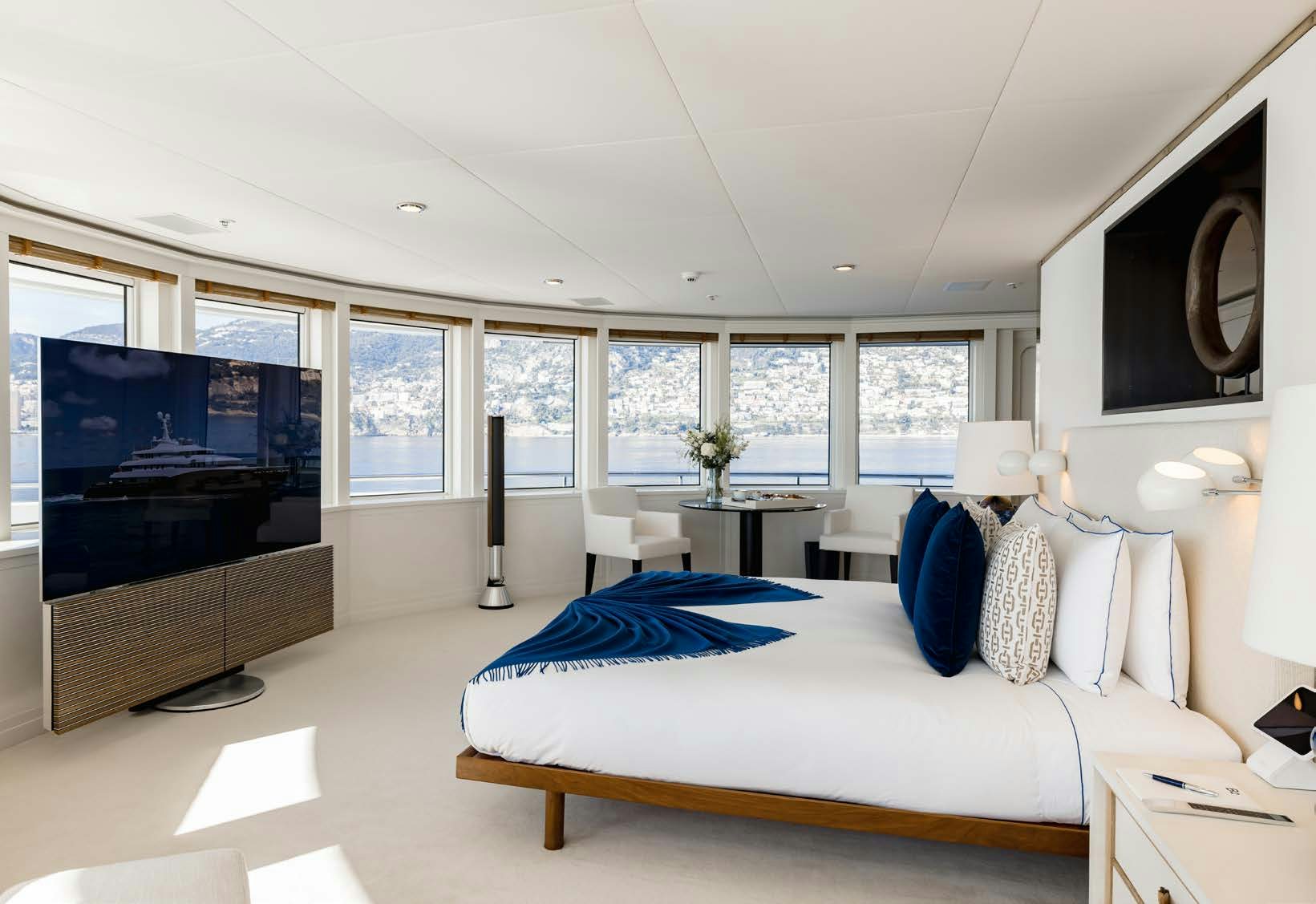 a bedroom with a large tv aboard HBC Yacht for Sale