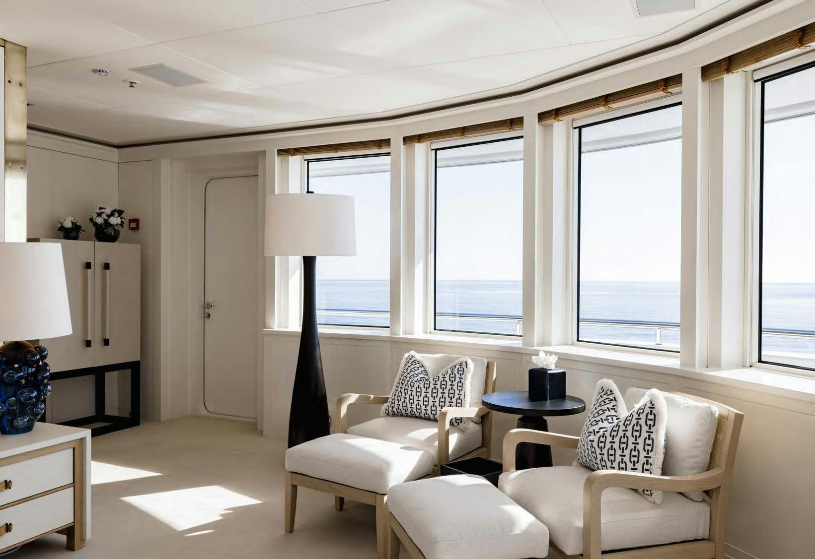 a living room with white furniture aboard HBC Yacht for Sale