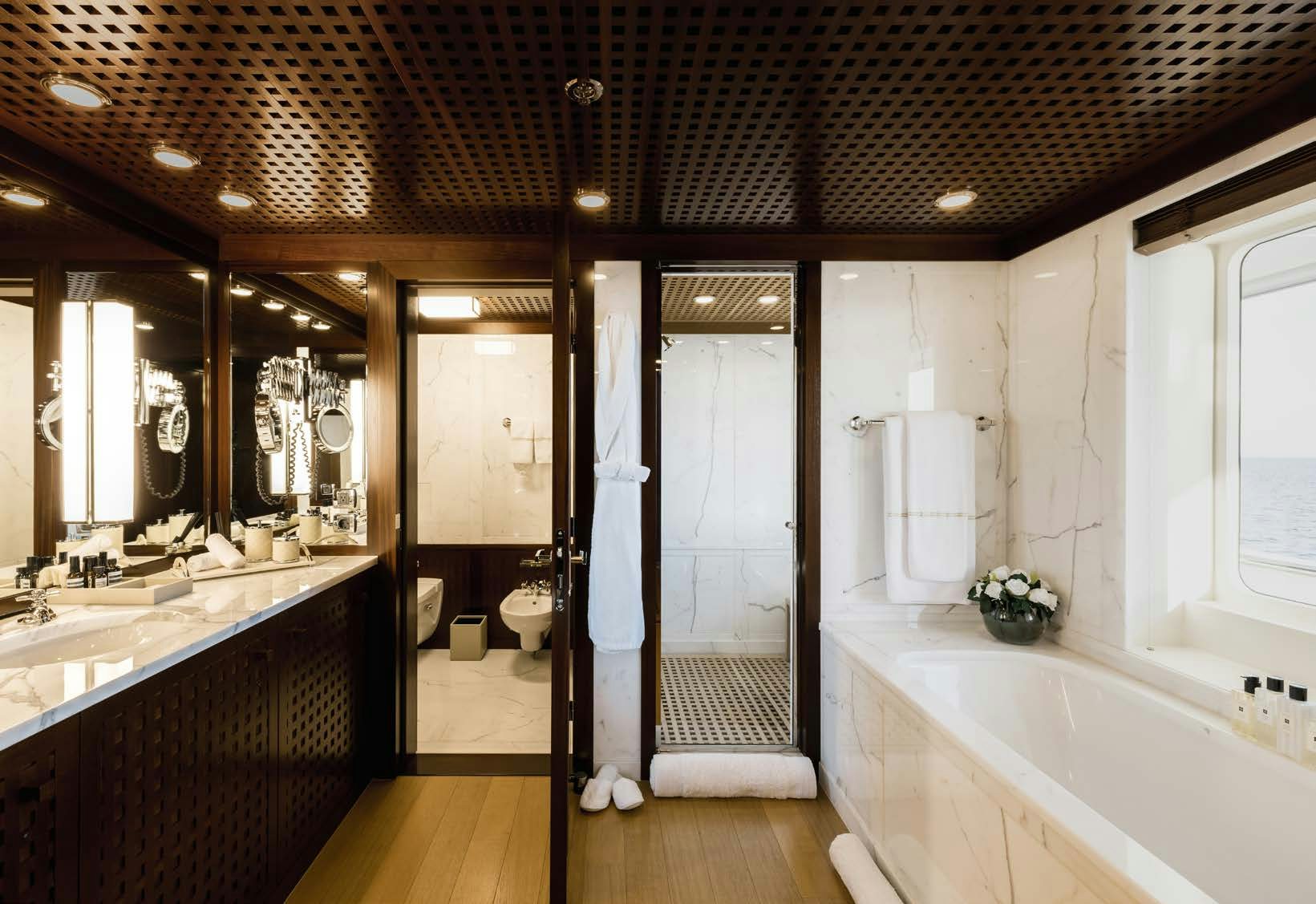 a bathroom with a tub sink and toilet aboard HBC Yacht for Sale