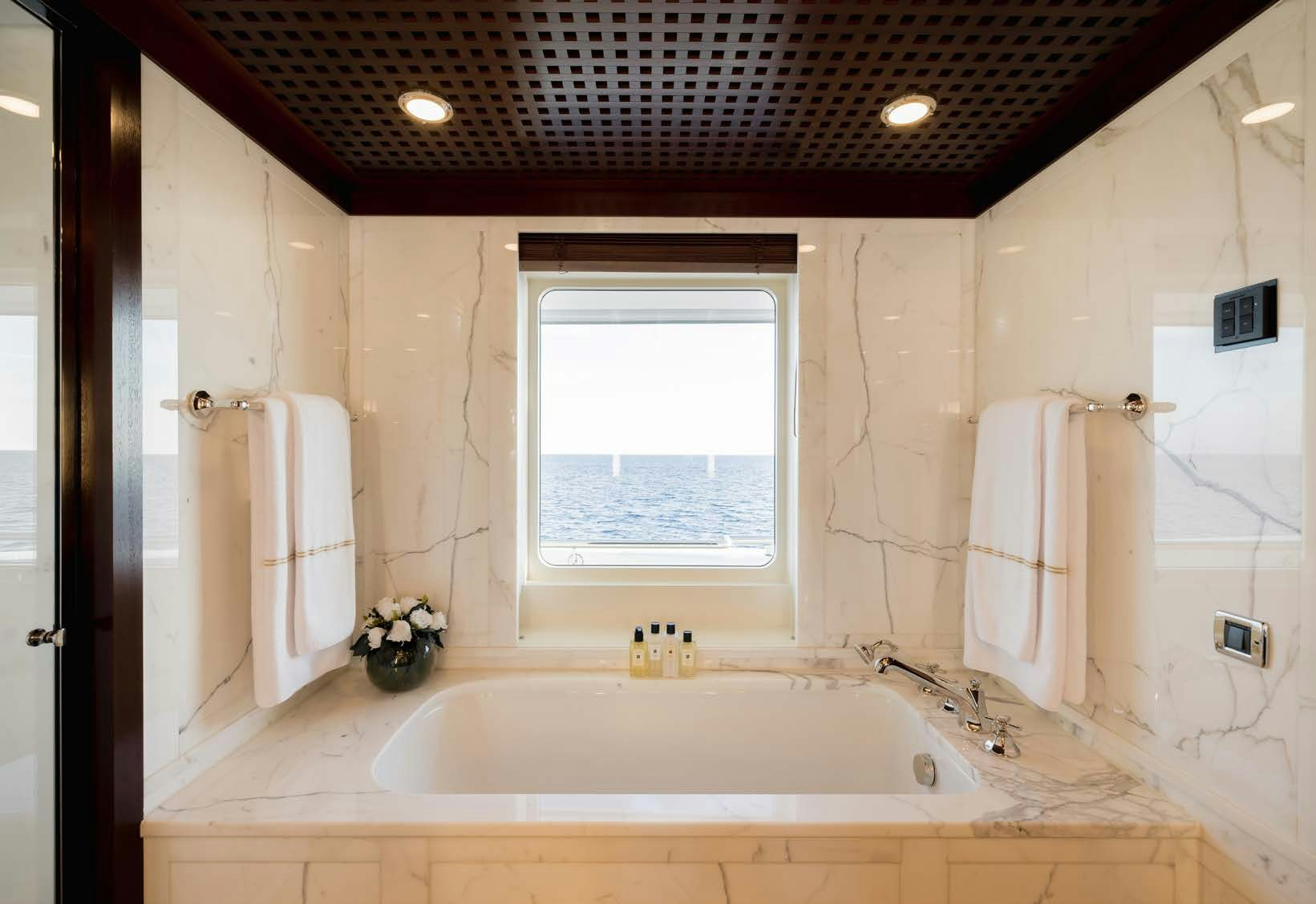a bathroom with a bathtub and a sink aboard HBC Yacht for Sale