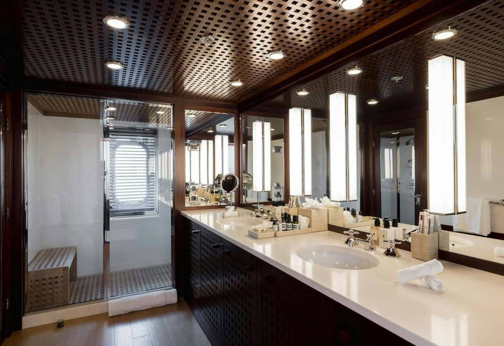 a bathroom with sinks and mirrors aboard HBC Yacht for Sale