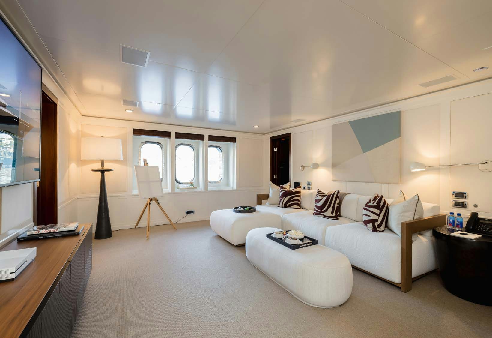 a living room with a white couch aboard HBC Yacht for Sale