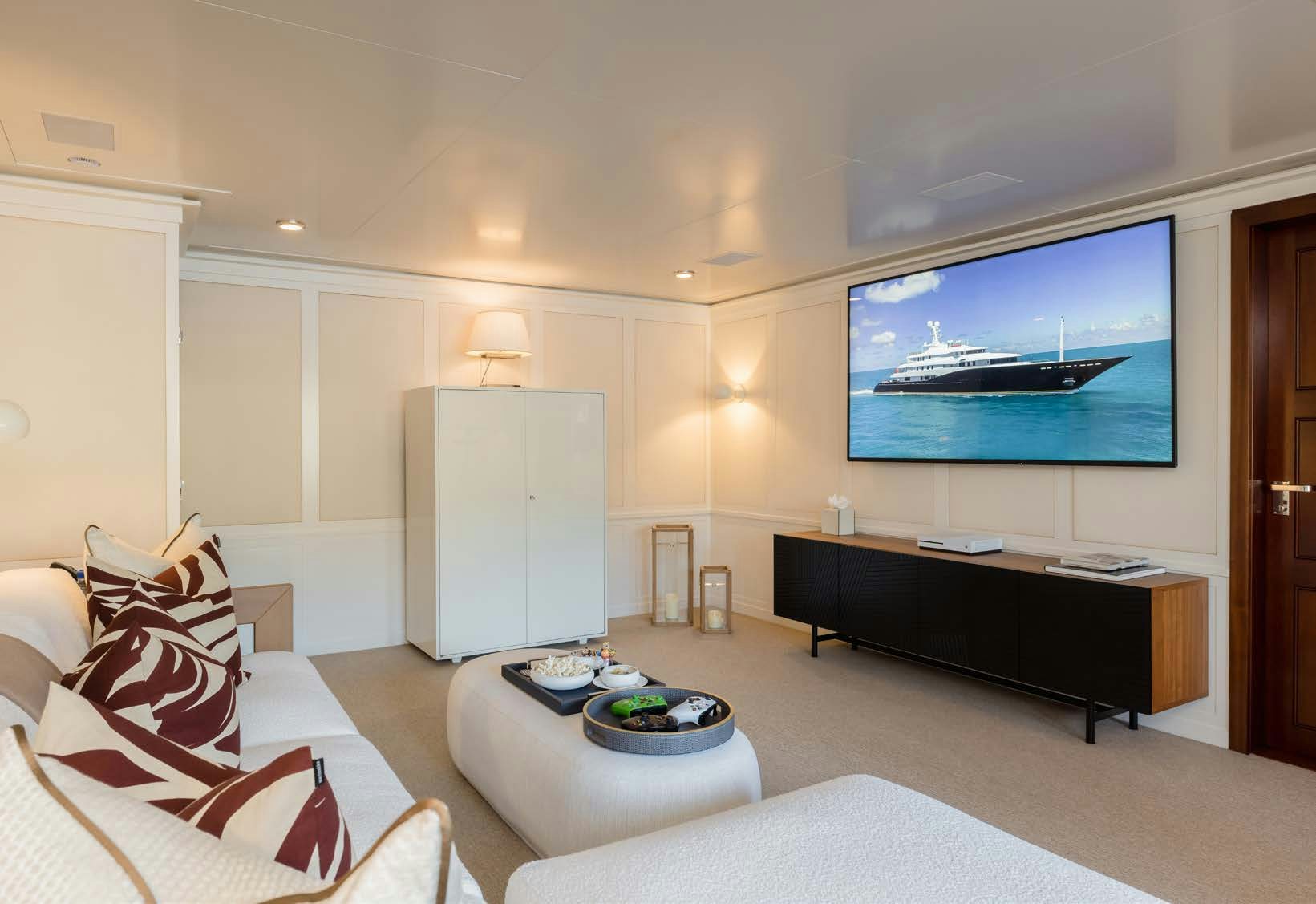 a living room with a tv and furniture aboard HBC Yacht for Sale