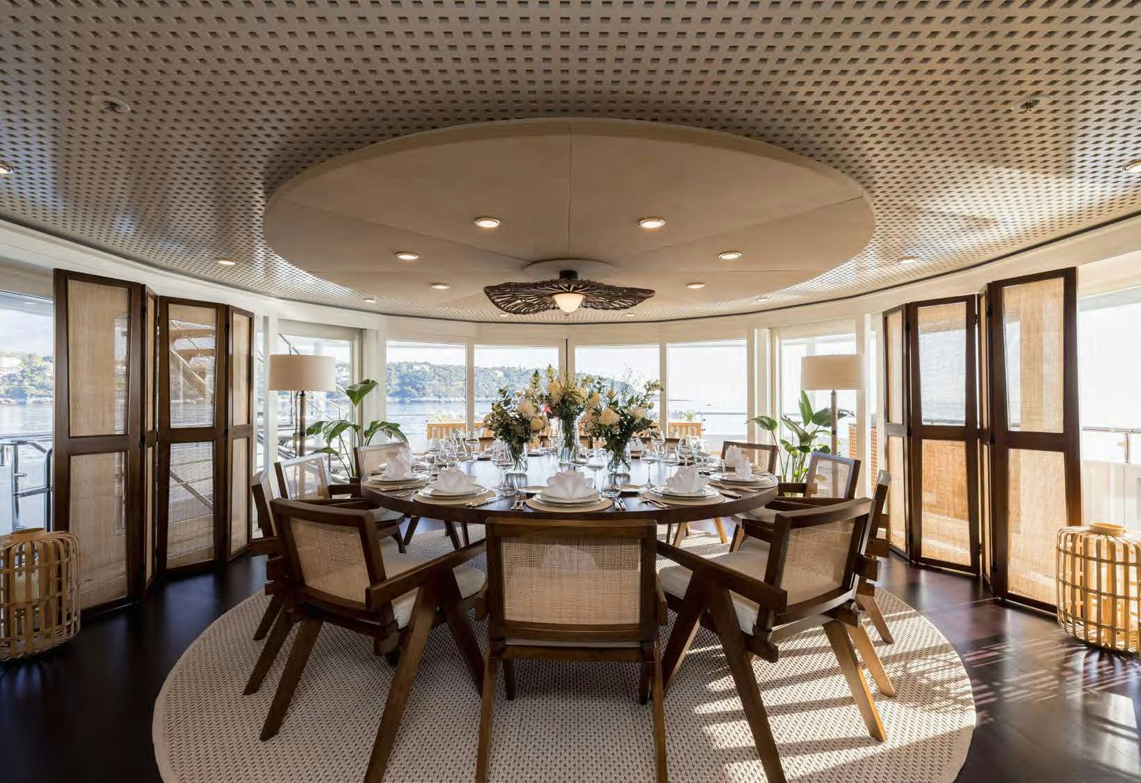 a dining room with a table and chairs aboard HBC Yacht for Sale