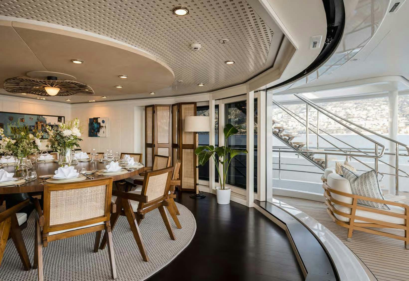 a dining room with a balcony aboard HBC Yacht for Sale