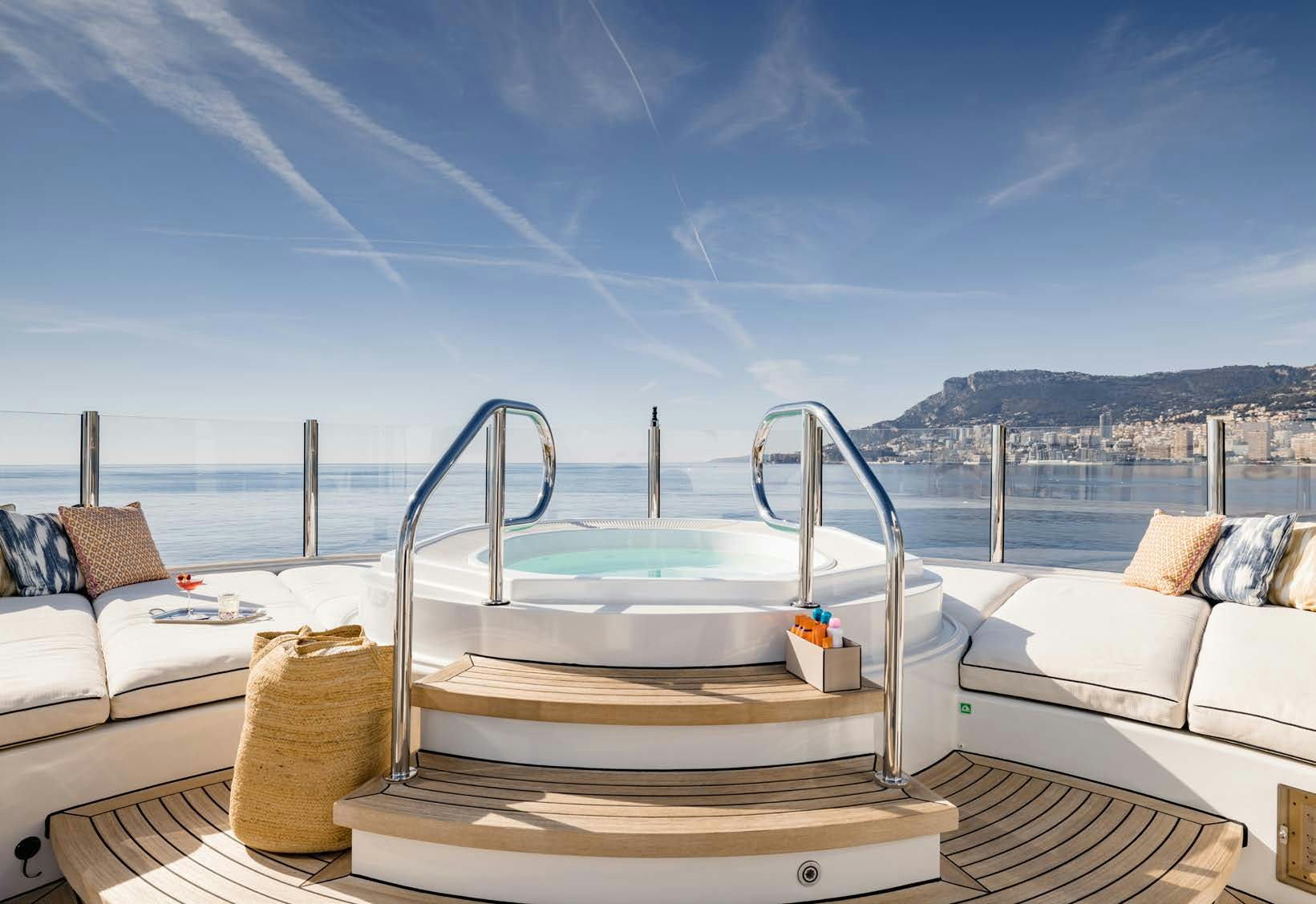 a large white bed with a pool behind it aboard HBC Yacht for Sale