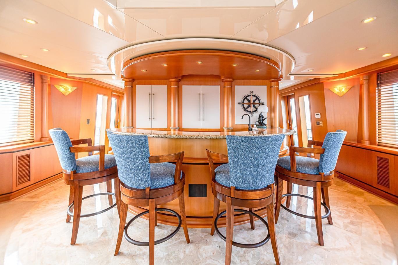 a table and chairs in a room aboard XOXO (118') Yacht for Charter
