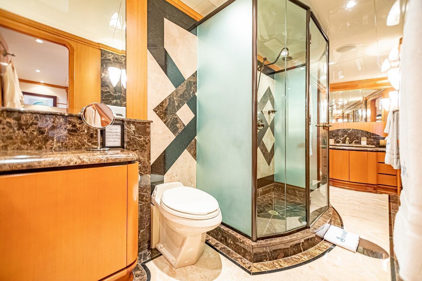 a bathroom with a glass shower aboard XOXO (118') Yacht for Charter