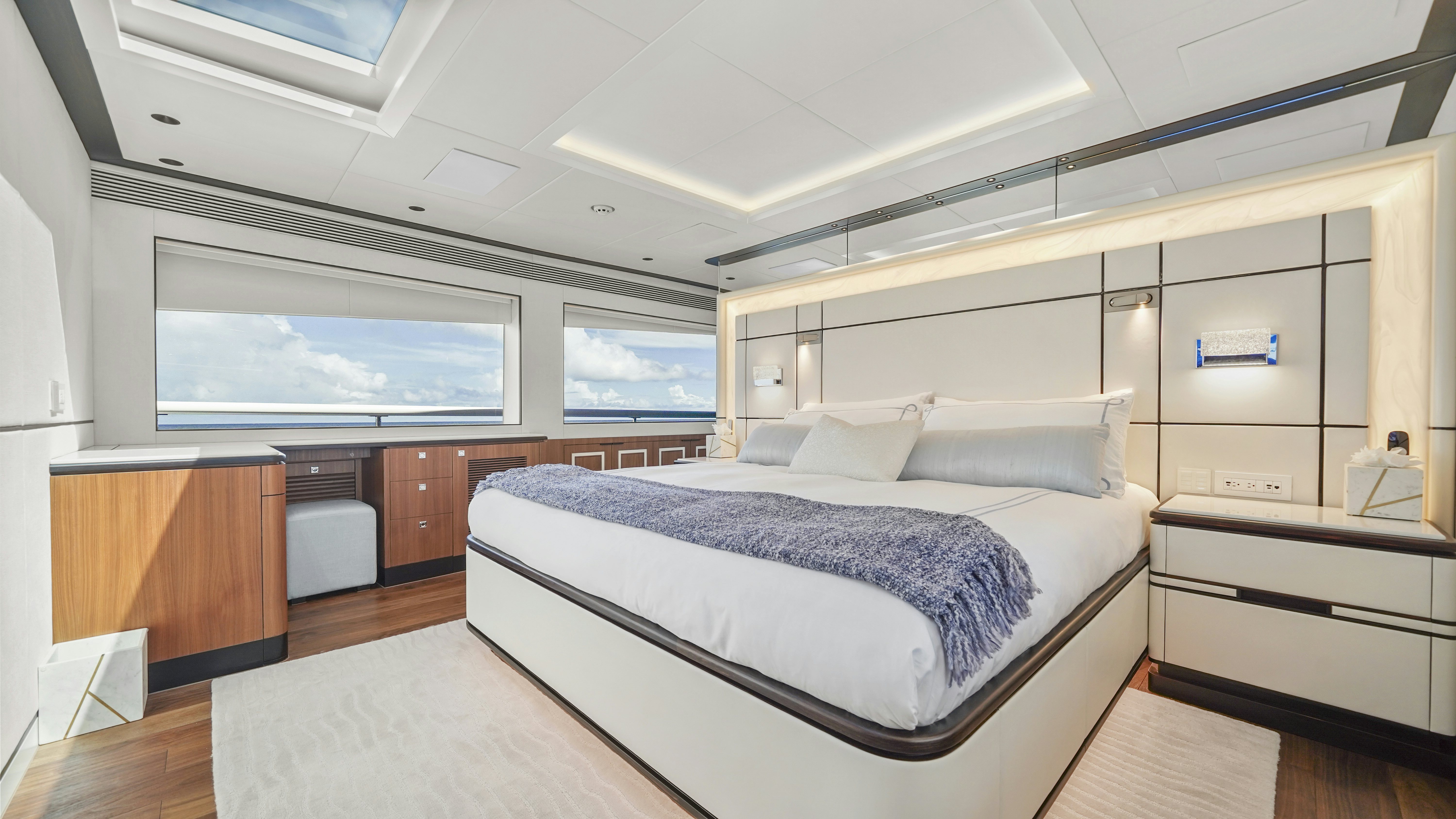 a bedroom with a bed and a window aboard MISS MICHELLE Yacht for Sale