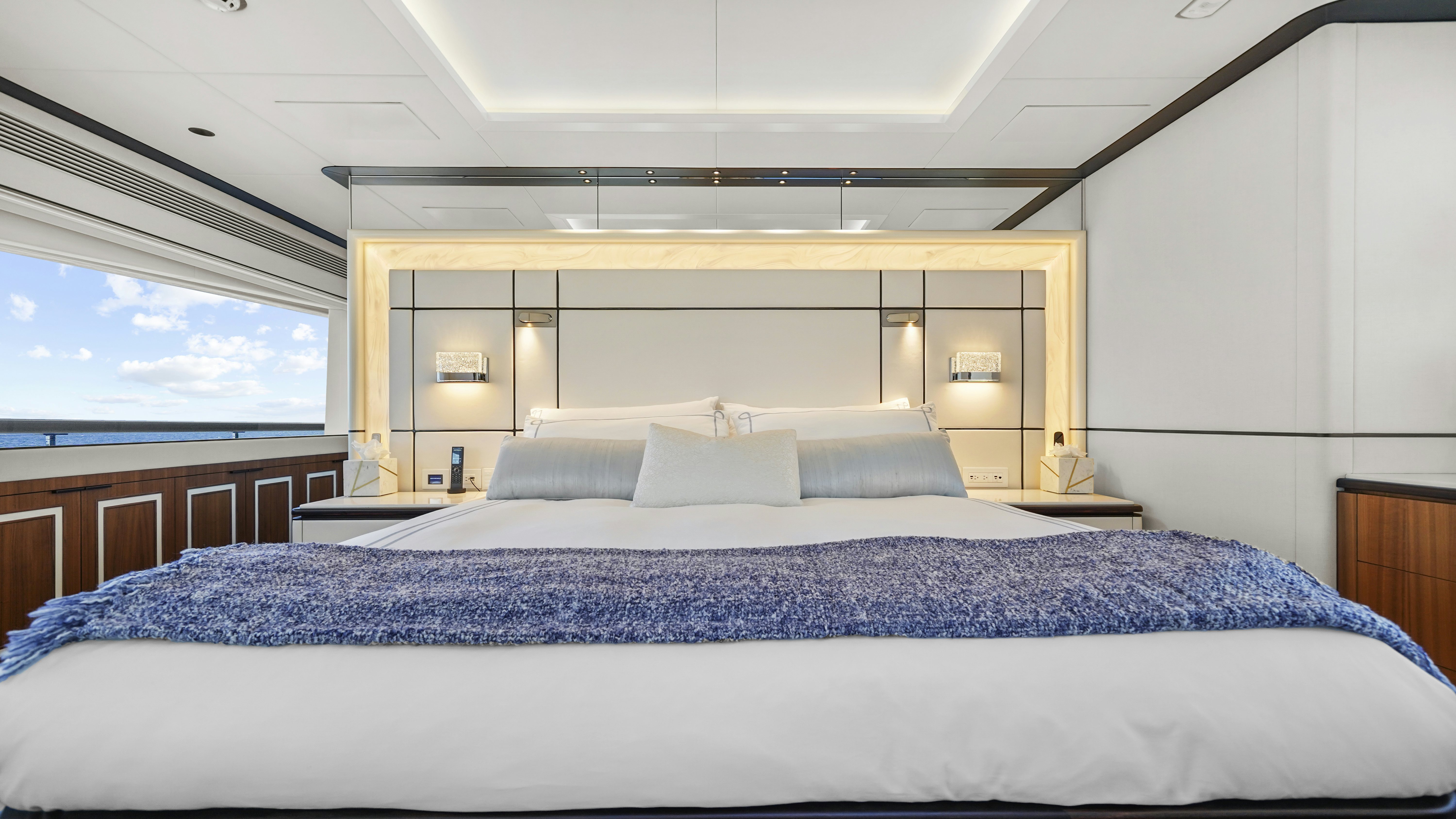a bed with a blue comforter aboard MISS MICHELLE Yacht for Sale