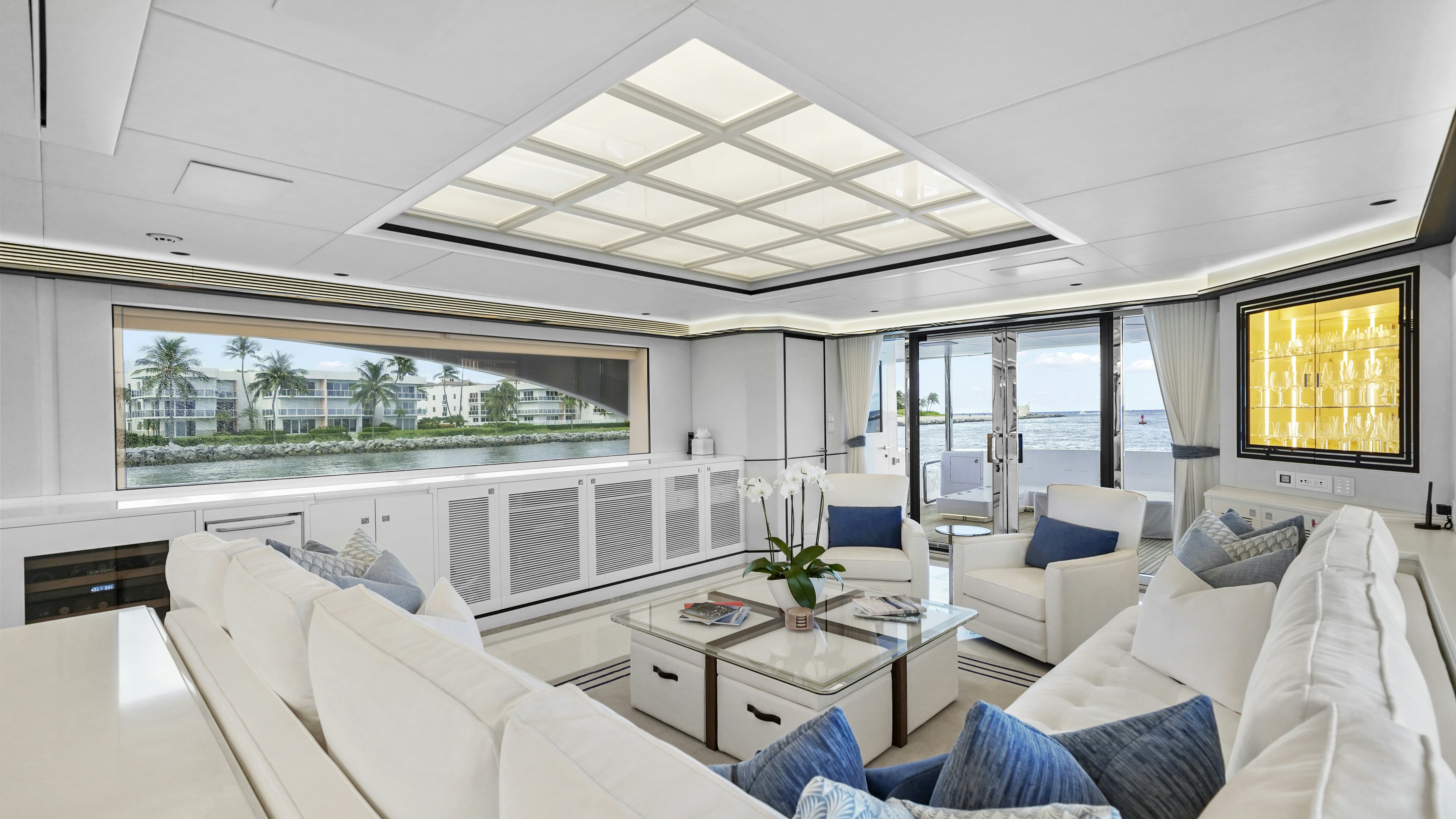 a room with a couch and a table and a window aboard MISS MICHELLE Yacht for Sale