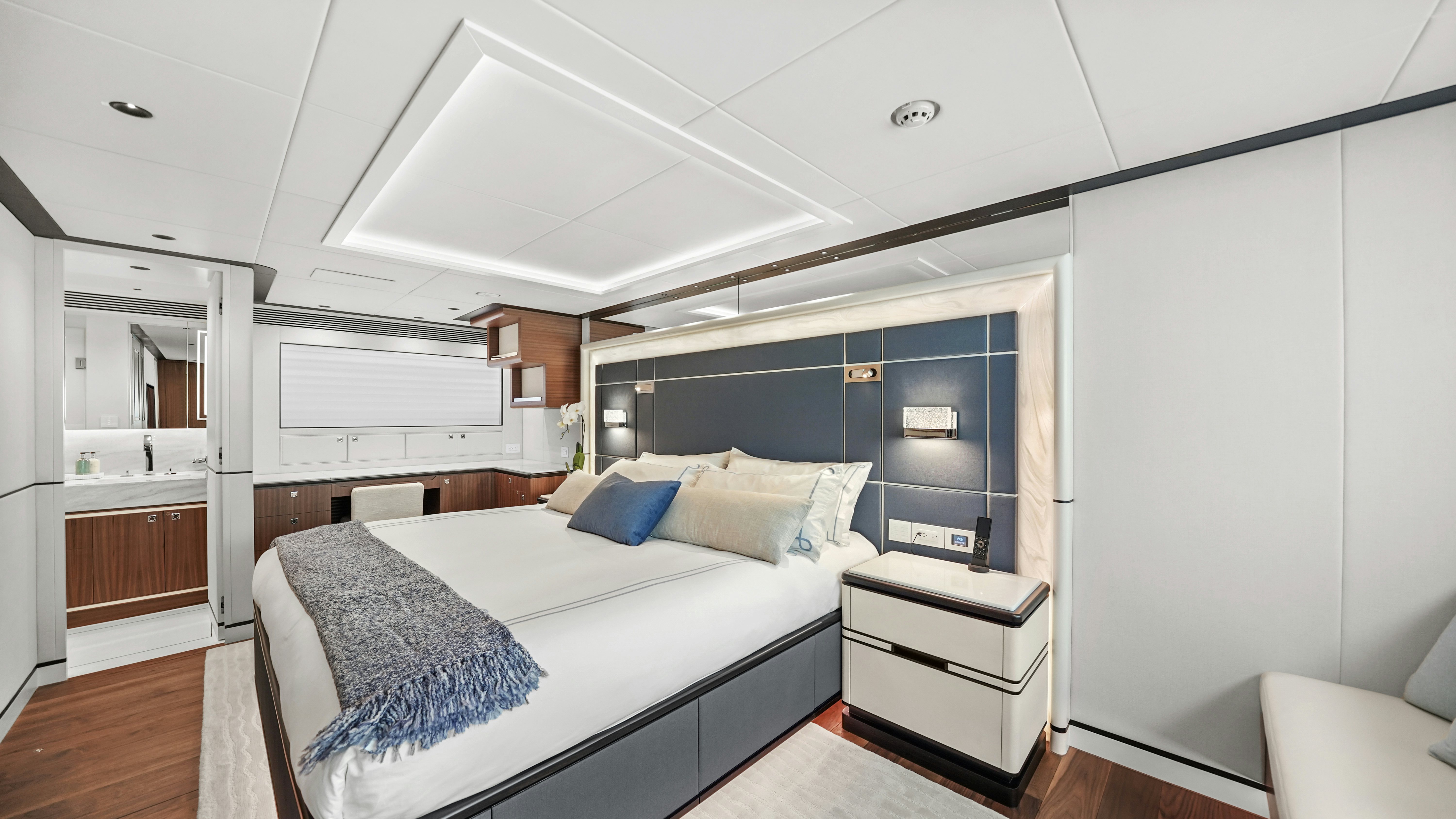 a bedroom with a bed and a desk aboard MISS MICHELLE Yacht for Sale