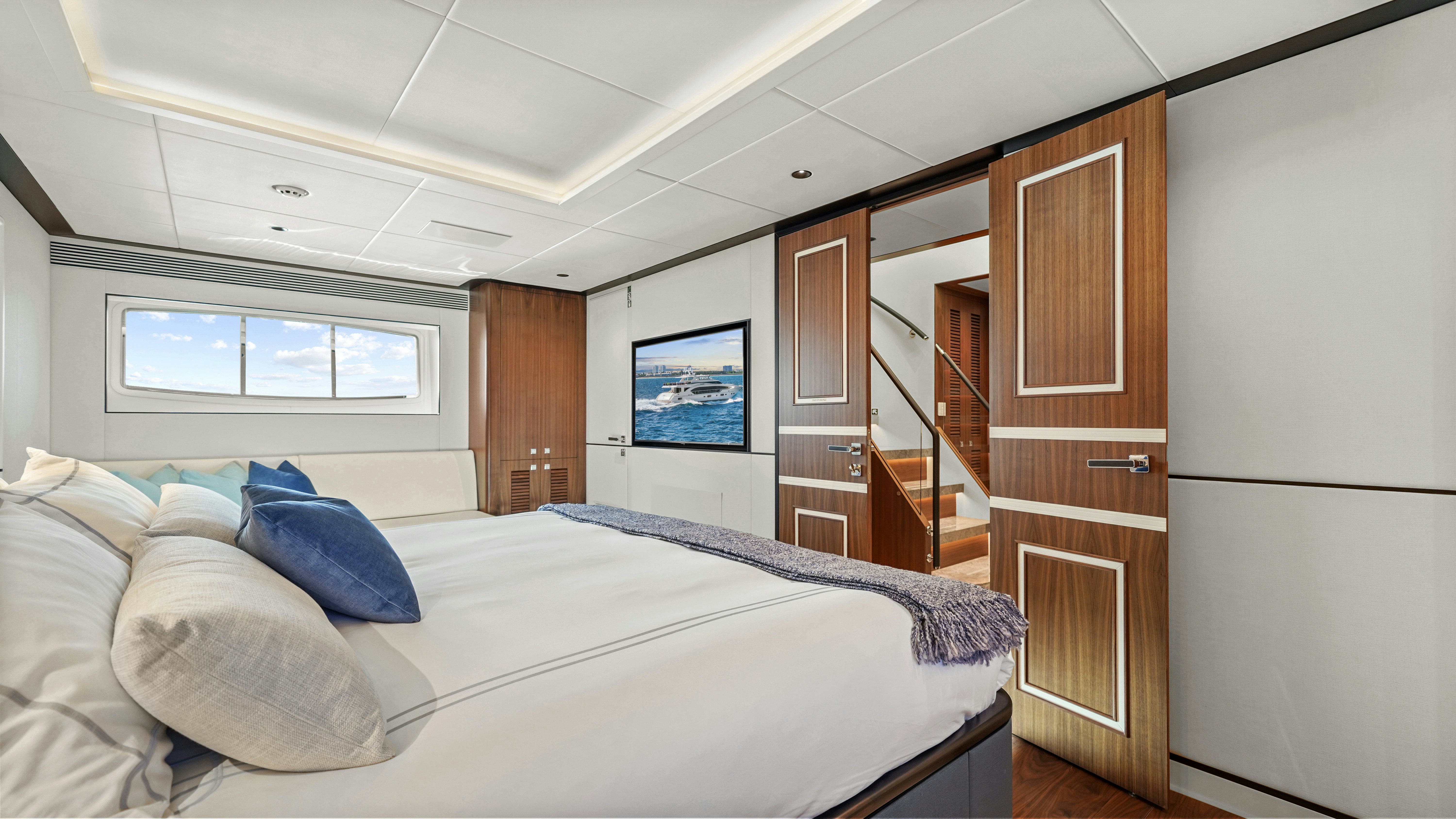 a bedroom with a bed and a closet aboard MISS MICHELLE Yacht for Sale