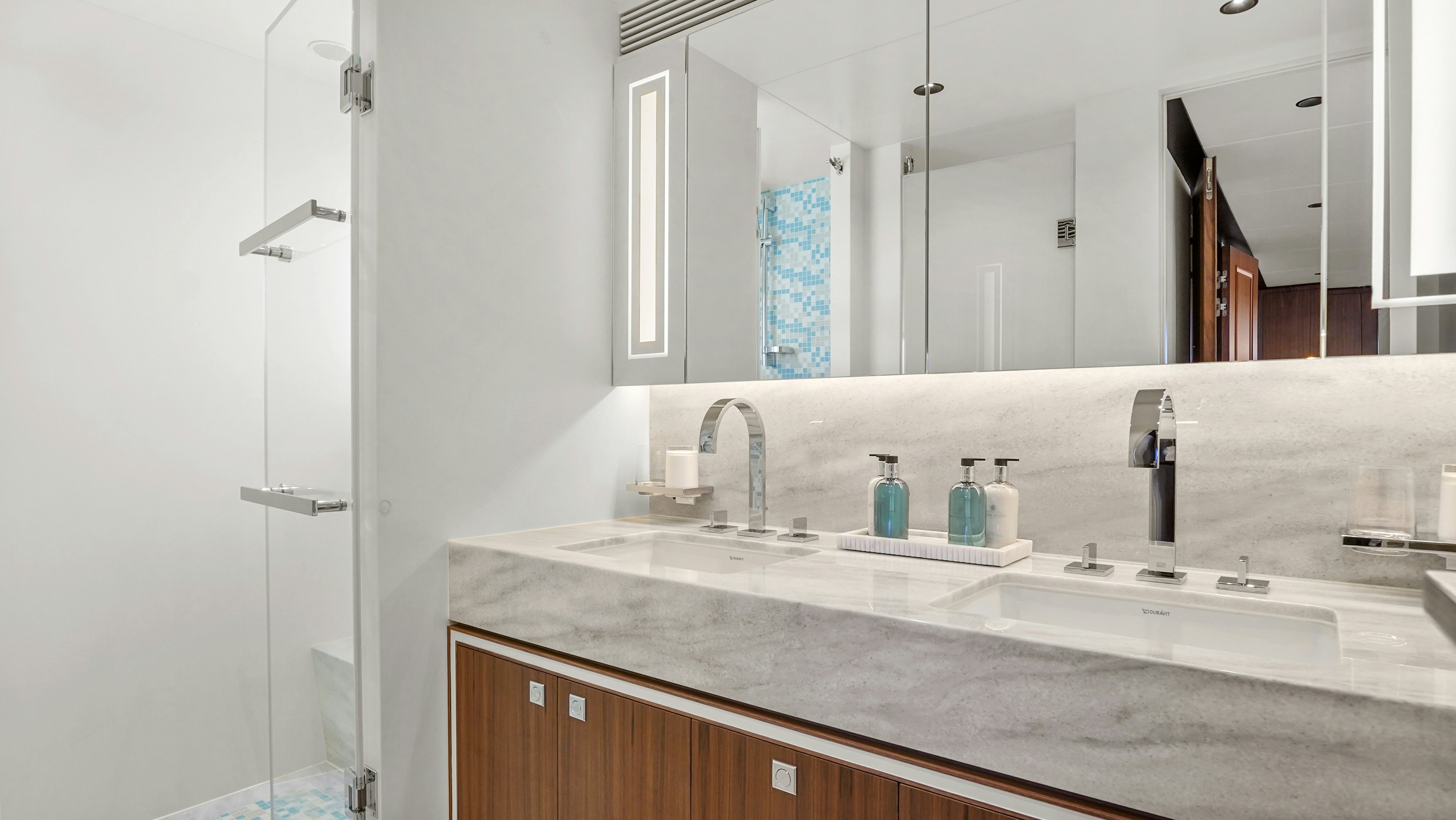 a bathroom with a large mirror aboard MISS MICHELLE Yacht for Sale