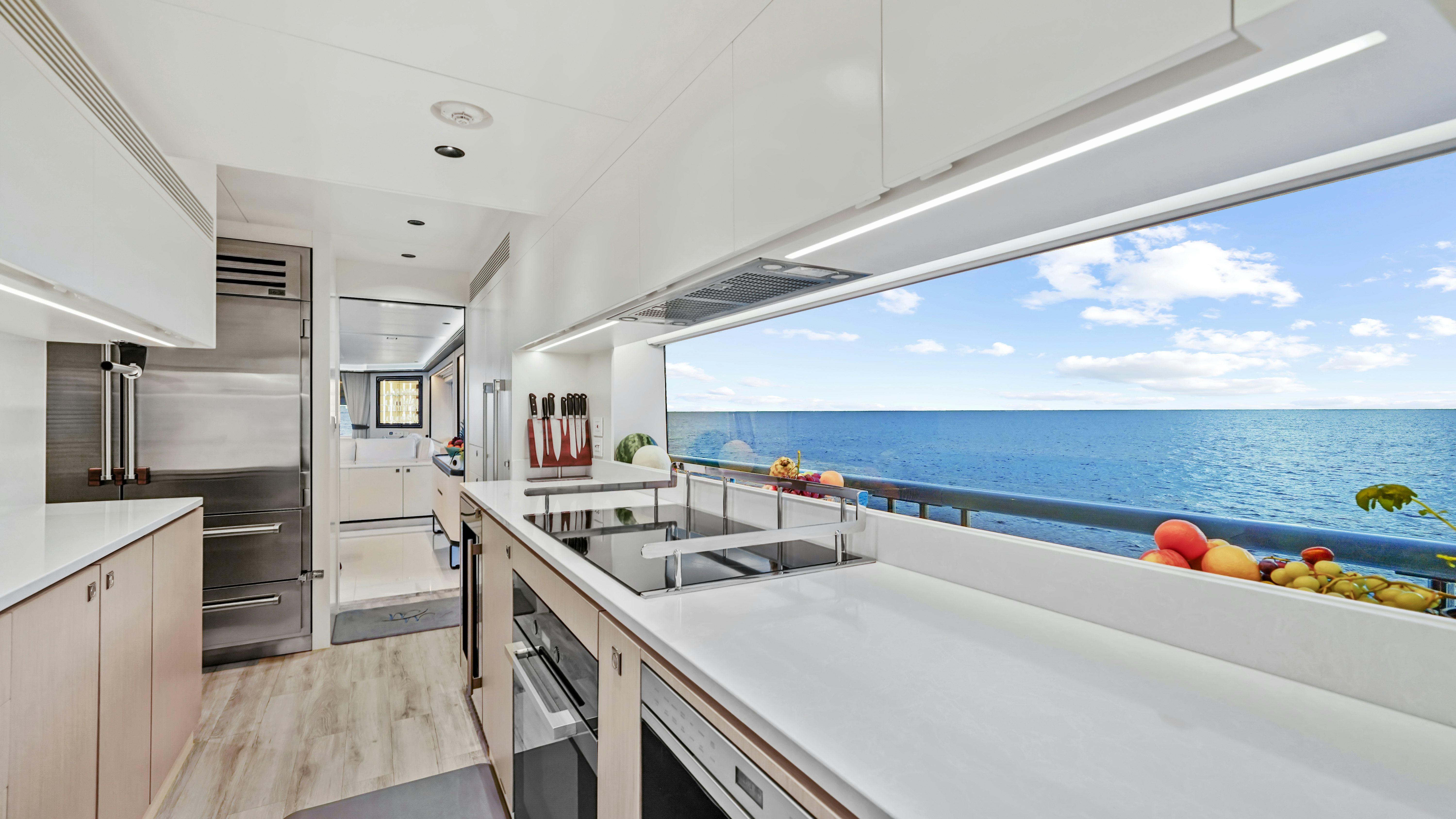 a kitchen with a large window overlooking the ocean aboard MISS MICHELLE Yacht for Sale