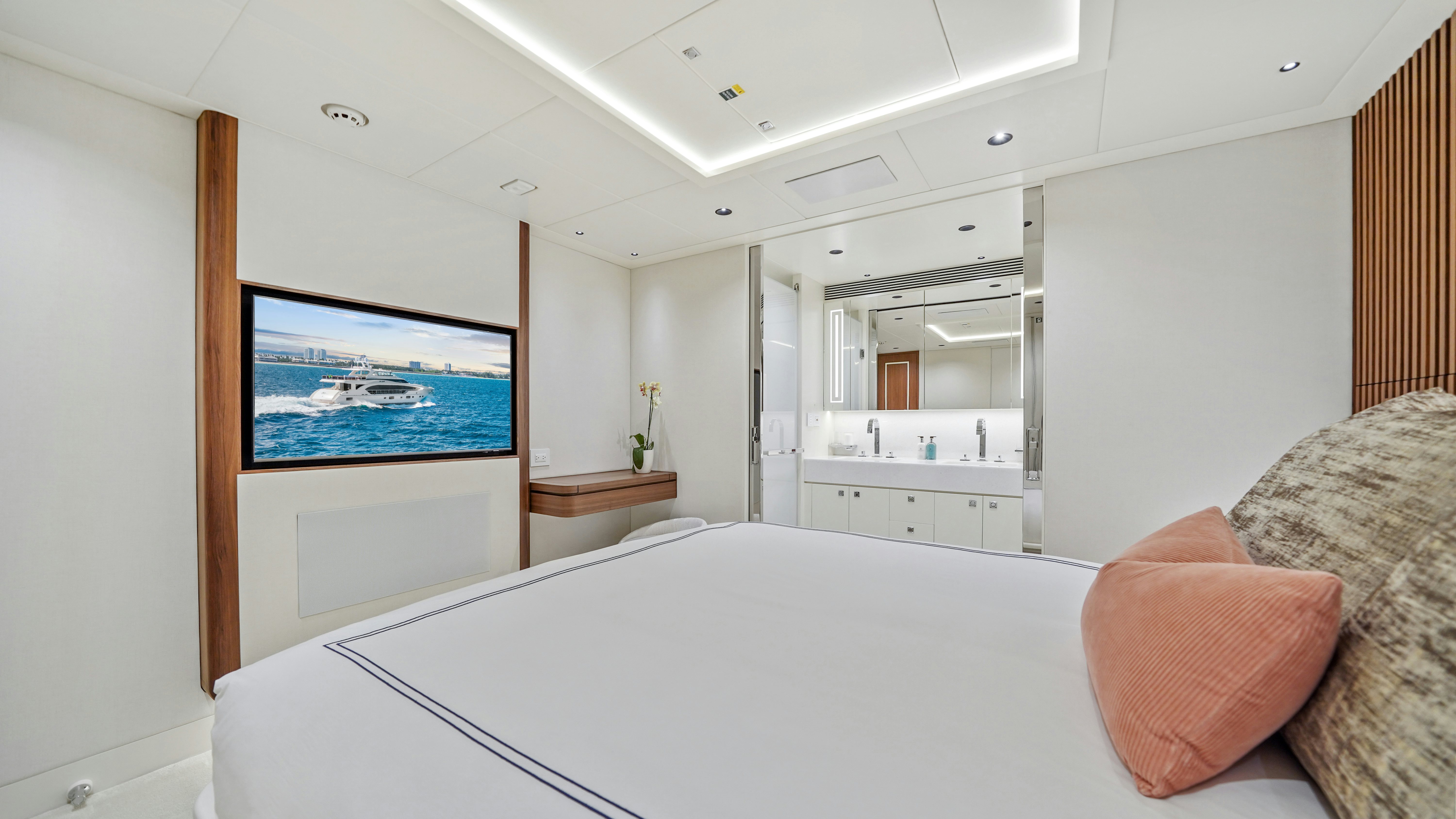 a large white bedroom with a large bed and a flat screen television aboard MISS MICHELLE Yacht for Sale
