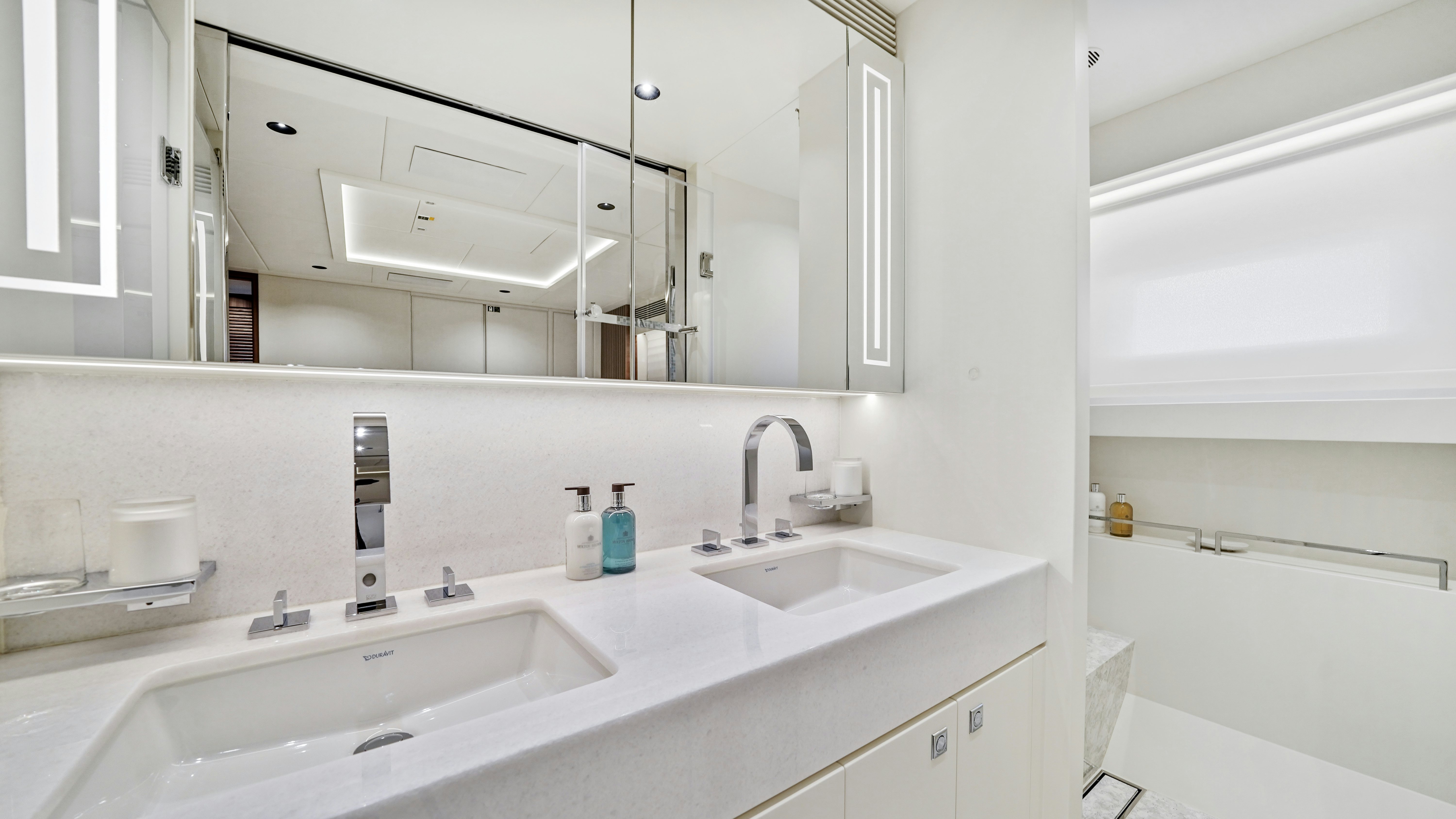 a bathroom with a large mirror aboard MISS MICHELLE Yacht for Sale