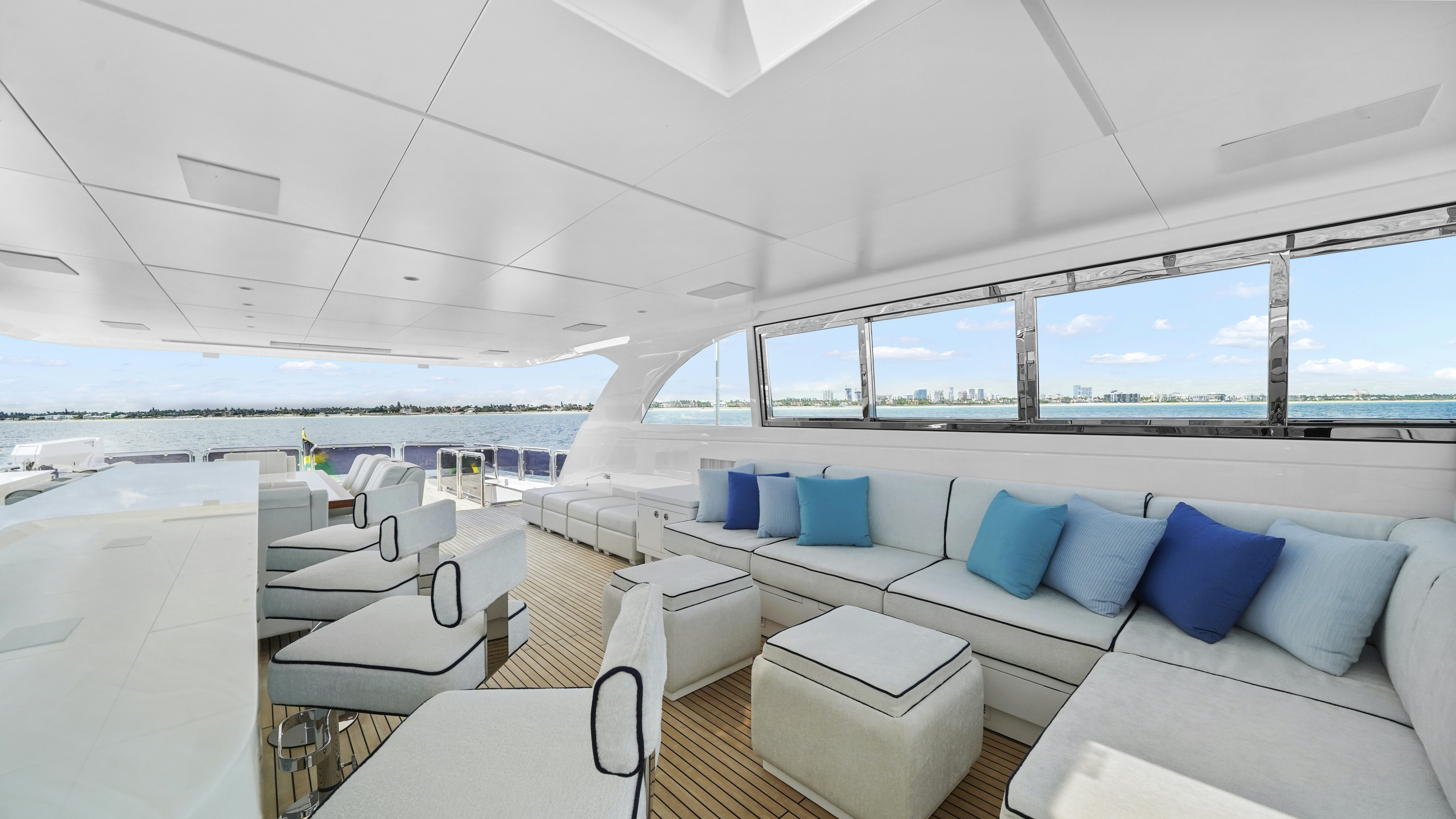 a room with a couch and a table with chairs aboard MISS MICHELLE Yacht for Sale