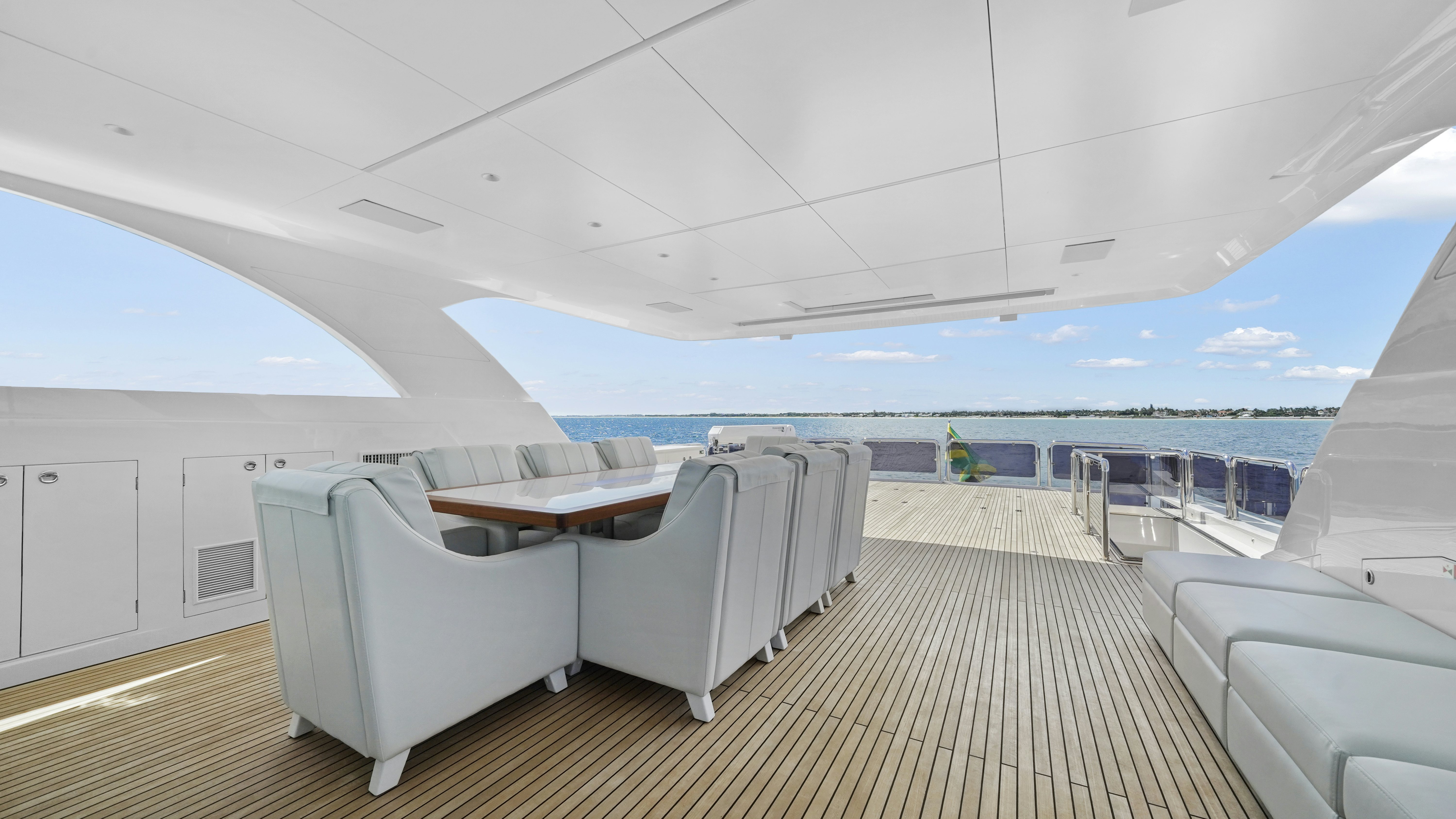 a room with a table chairs and a large body of water aboard MISS MICHELLE Yacht for Sale