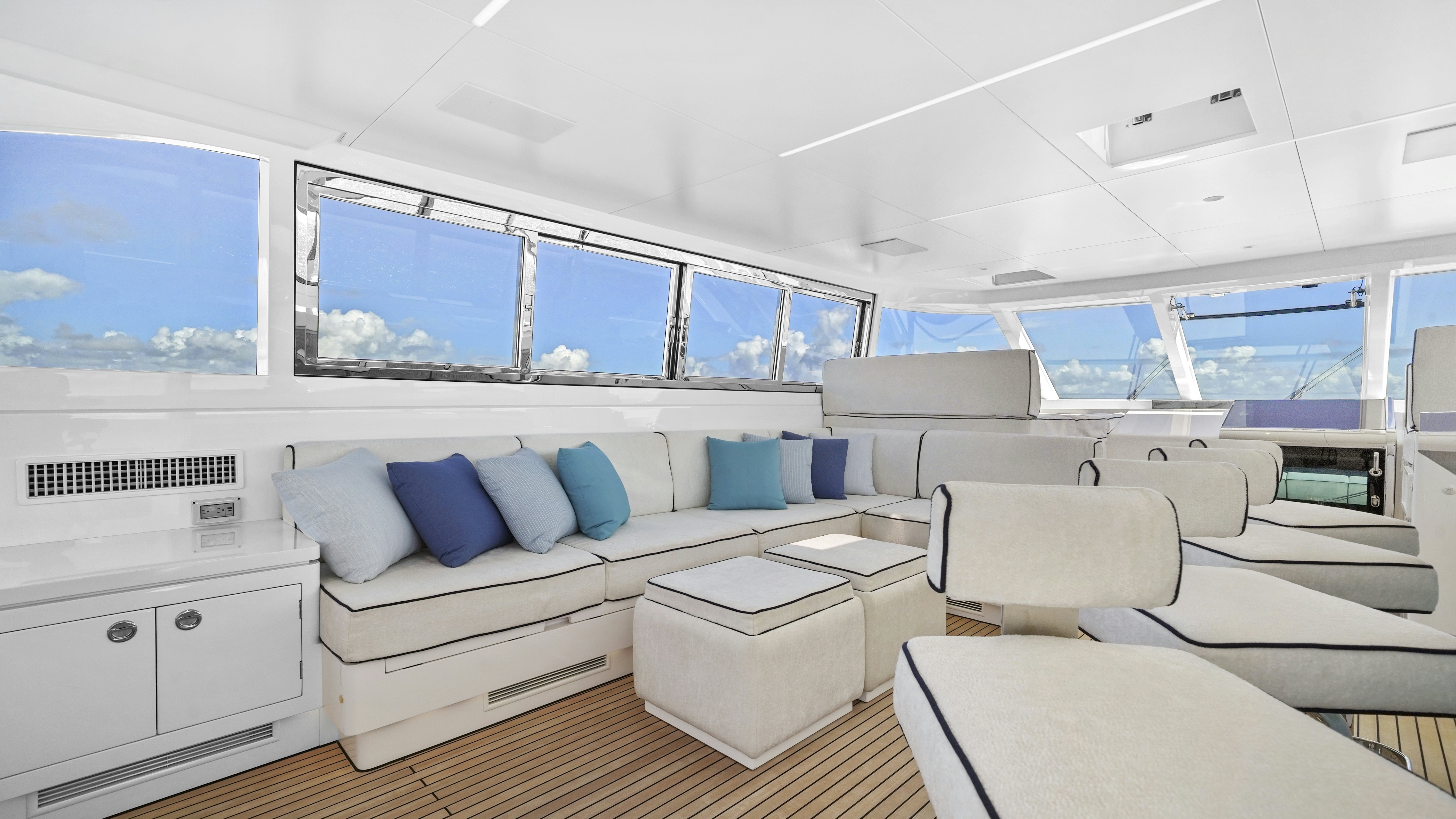 a white living room with a large window aboard MISS MICHELLE Yacht for Sale