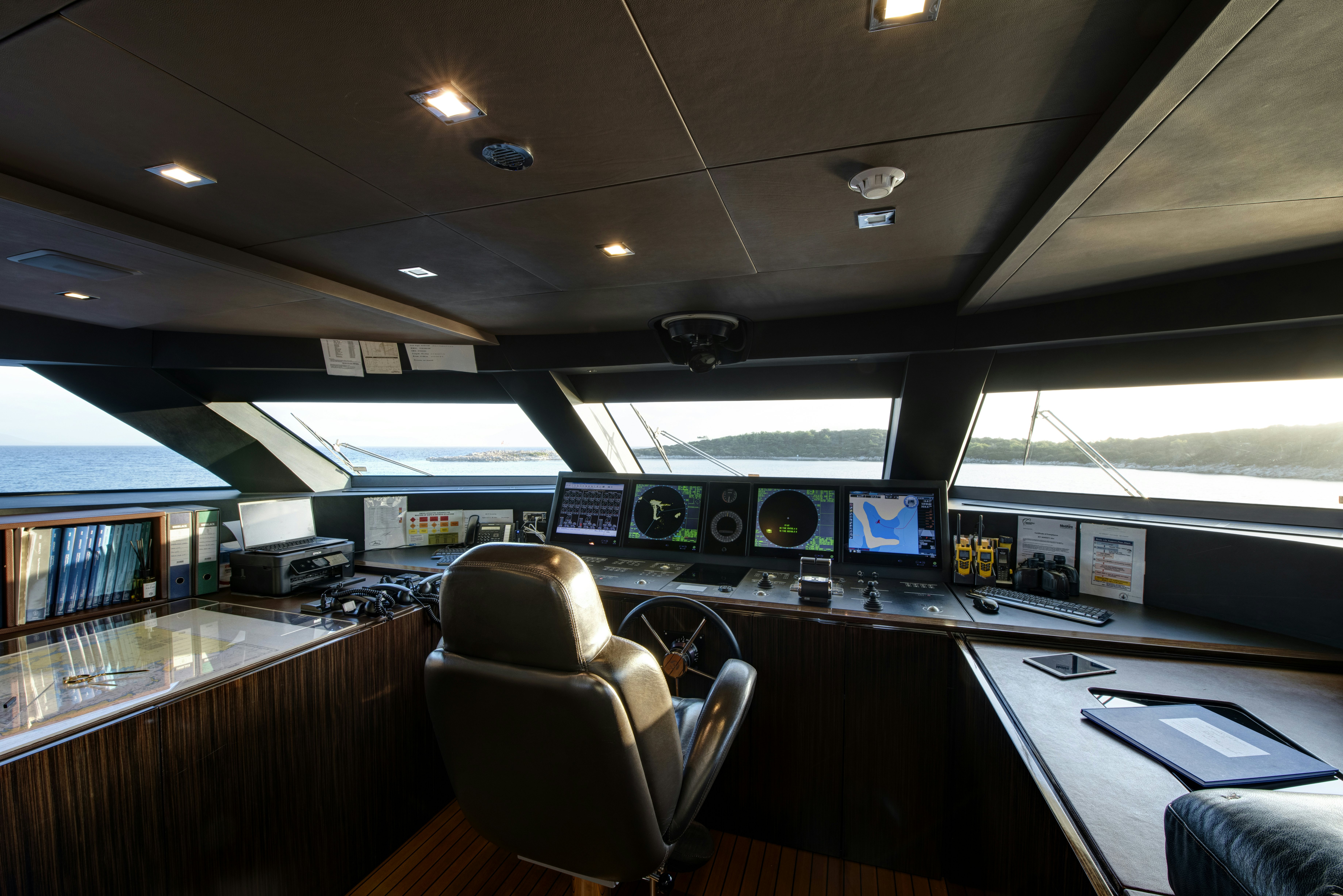 inside of a building with a desk and chairs aboard SERENITY Yacht for Sale