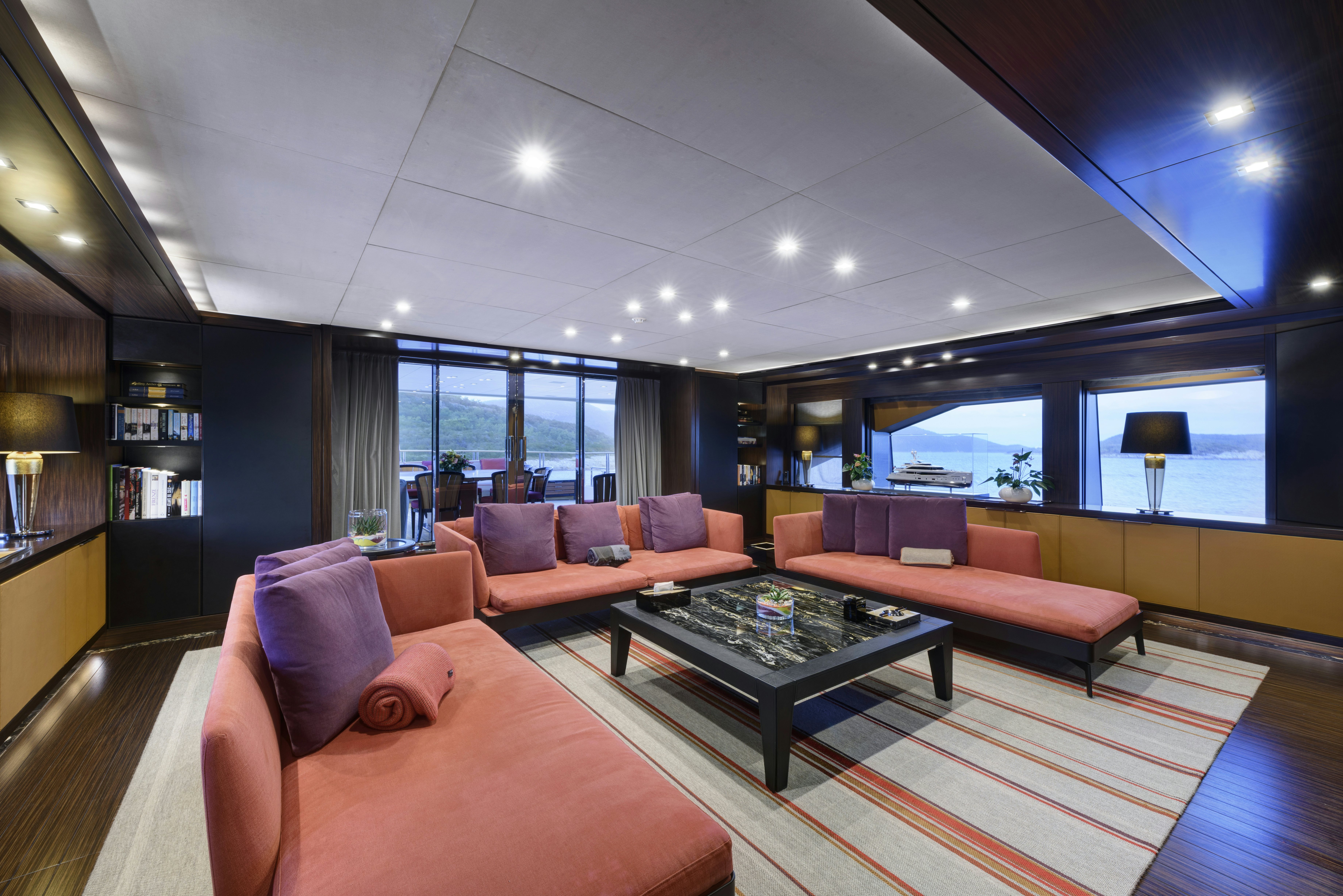 a living room with a large window aboard SERENITY Yacht for Sale